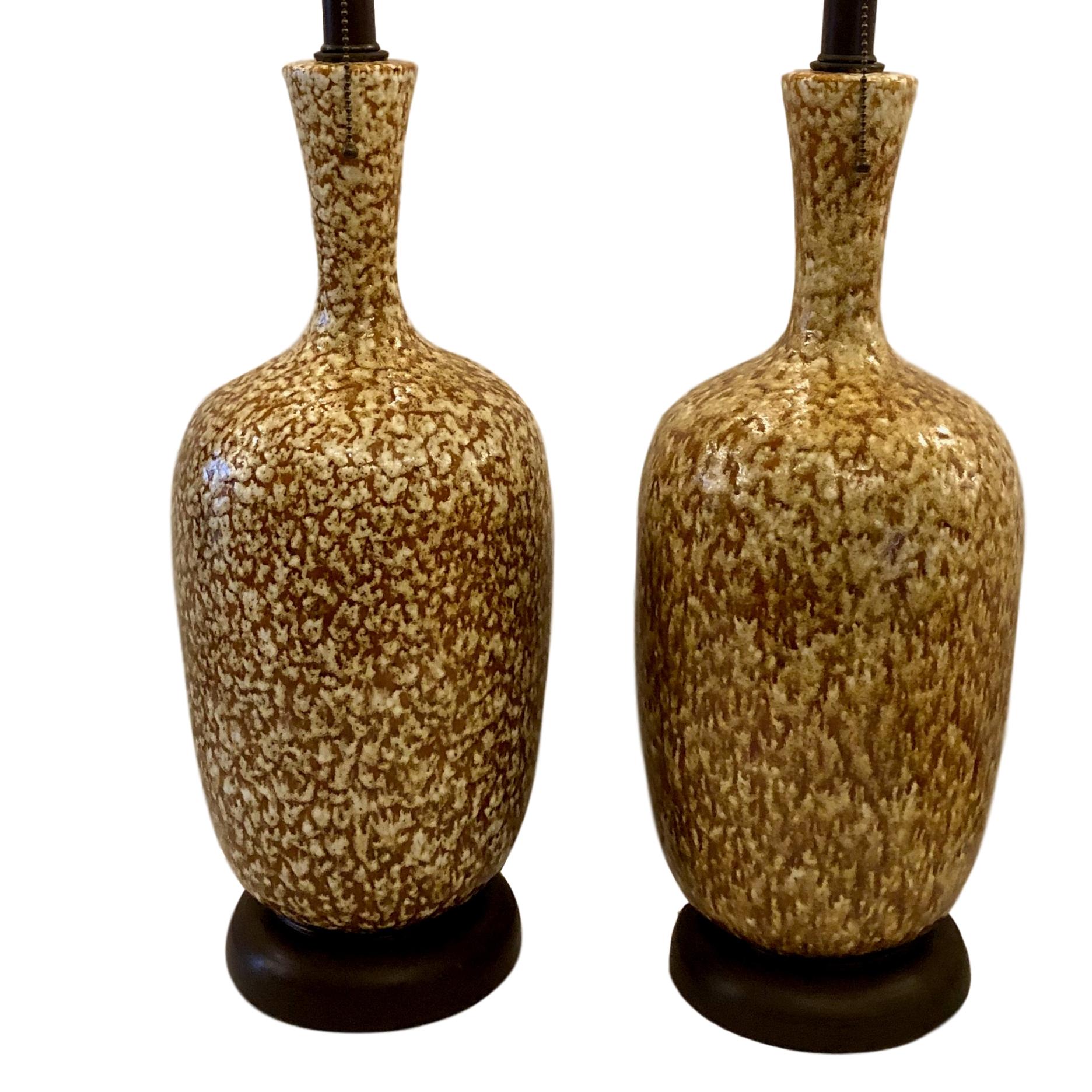 Pair of circa 1950's Italian glazed ceramic table lamps with wooden bases.

Measurements:
Height of body 18