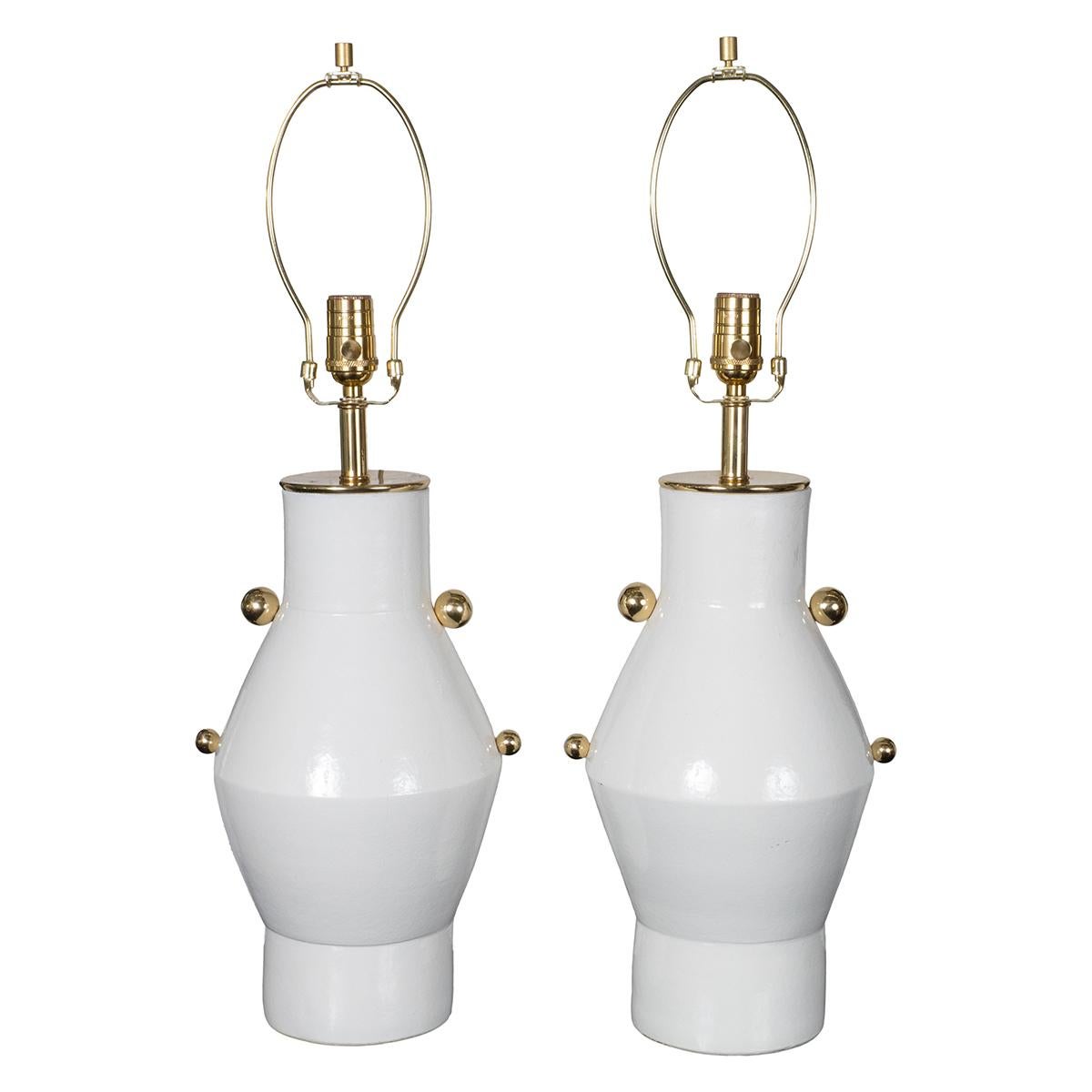 Pair of glazed ceramic vessel table lamps with brass ball details.