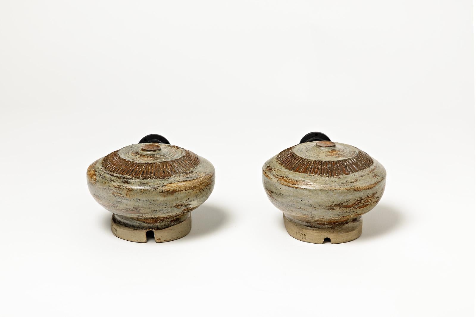 Pair of glazed ceramic wall lamps, green and brown by Robert Héraud.
Artist signature under the base. Circa 1960.

H : 7.1’ x 6’ x 3.9’ inches (ceramic only).
H : 9’4 x 6’ x 3.9’ inches (ceramic and electrical system).
Sold with a European