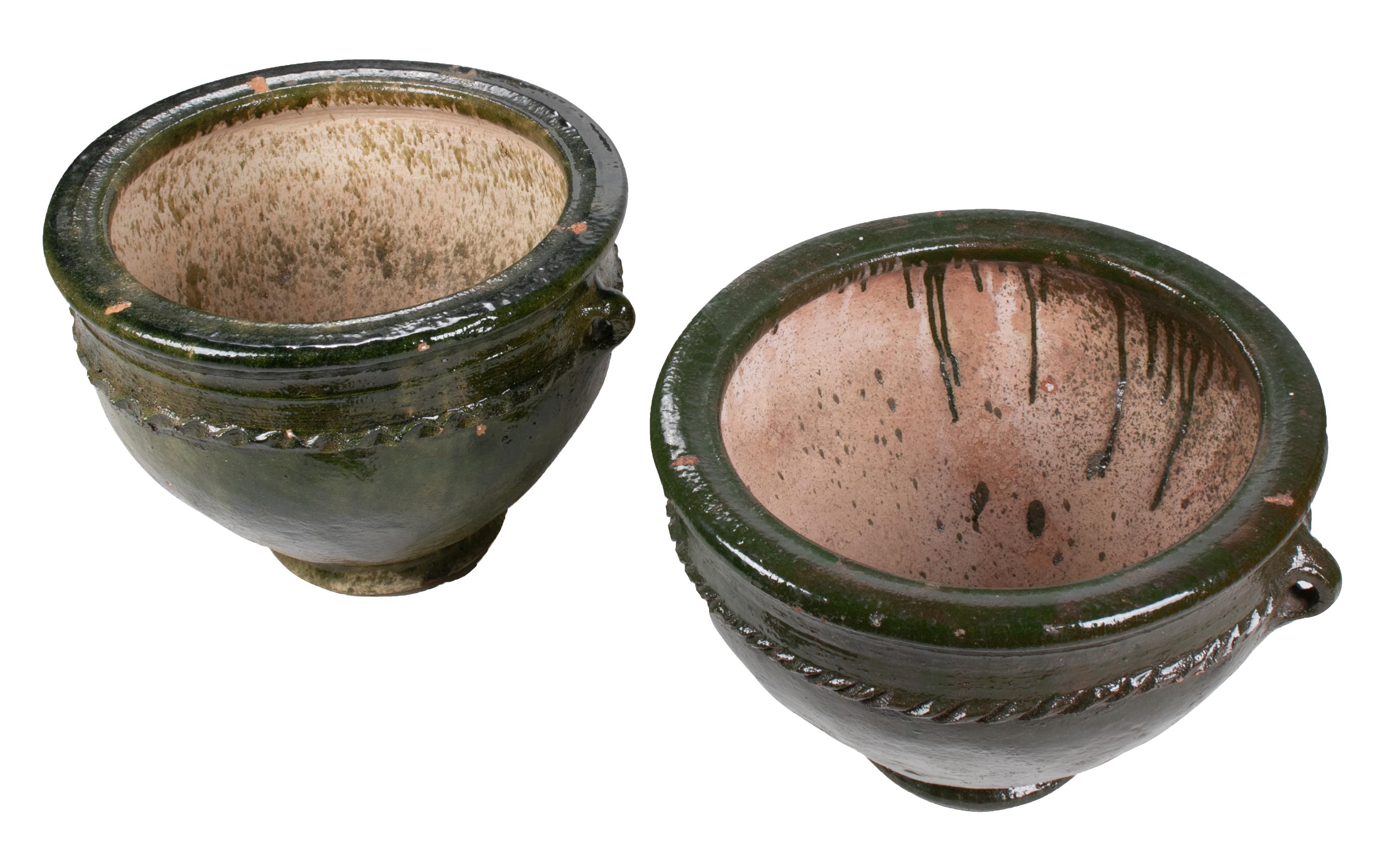 Pair of glazed green ceramic pots.