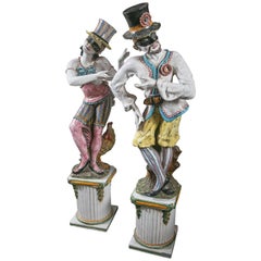 Pair of Glazed Terra Cotta Masqueraders