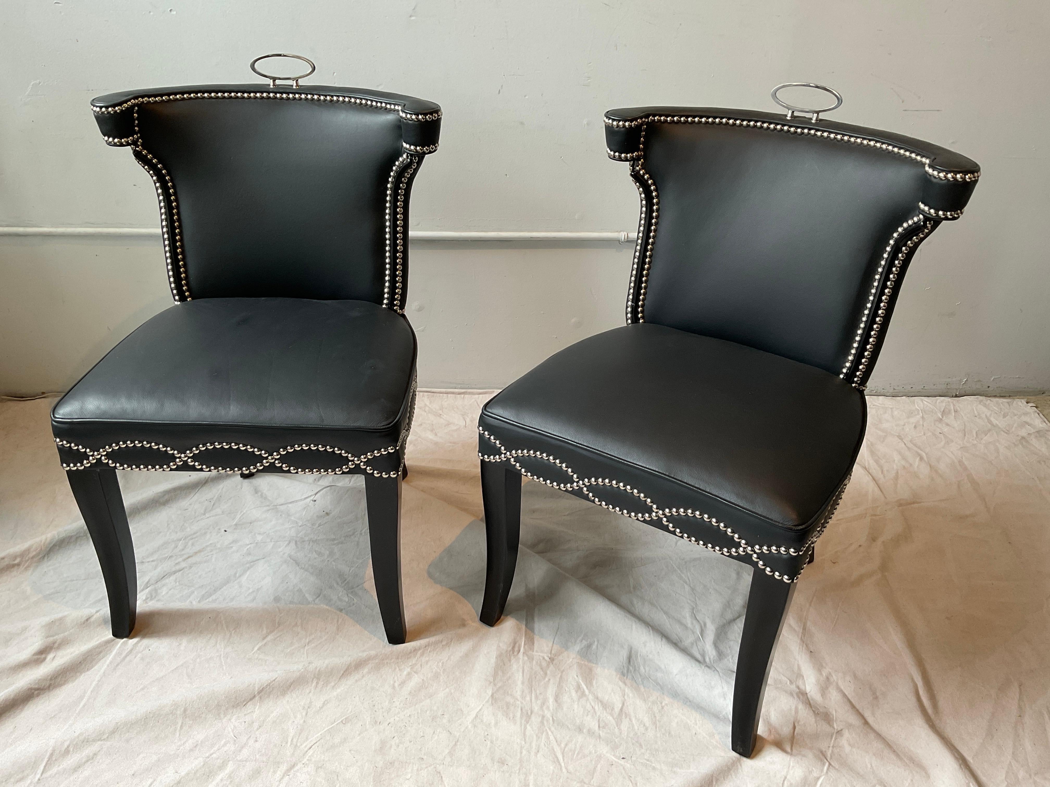 Pair of Global Views Casino black leather chairs.