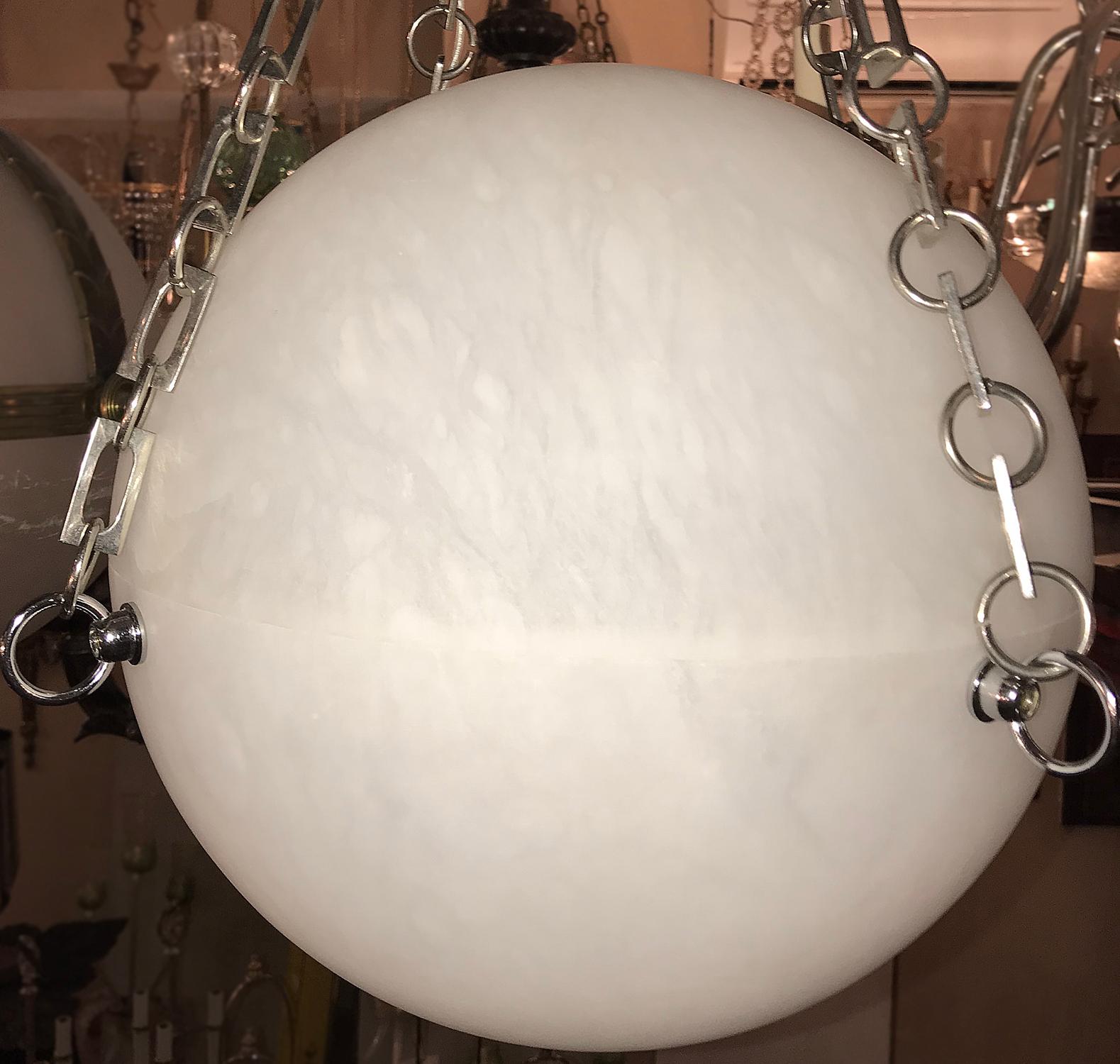 A pair of circa 1950's globe lanterns with nickel plated chains and 4 interior lights. Sold individually.

Measurements:
Diameter: 24″
Min. drop: 30″