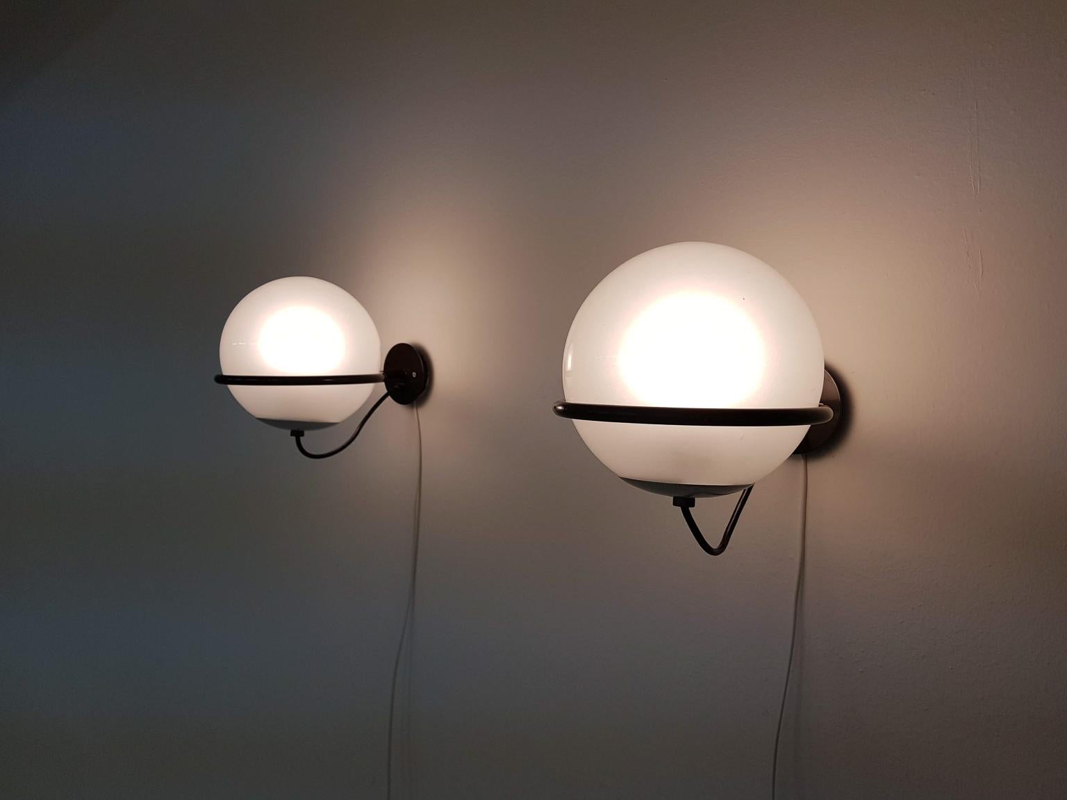 Authentic, vintage and matching pair of Model 238/1 wall lights or sconces by Italian master designer Gino Sarfatti for Arteluce, Italy 1959.

The lamp consists of a frosted glass globe which rests on a brown lacquered metal ring. Lamp and metal