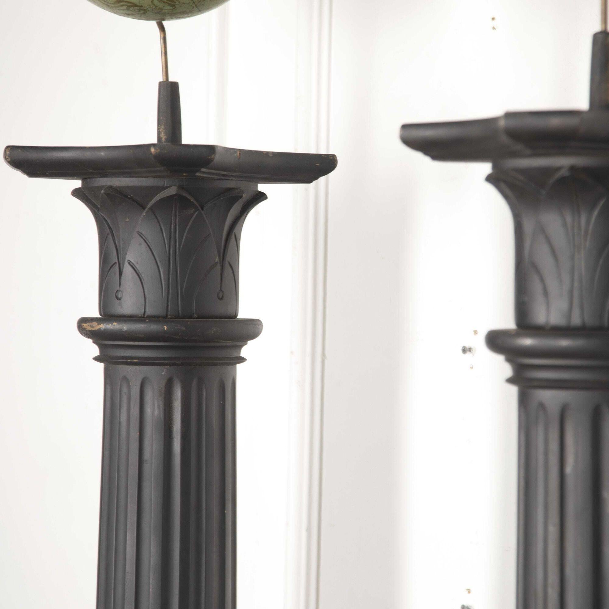 Pair of American terrestrial and celestial globes mounted on column stands. 
The globes were made by Weber Costello Co. - USA. The ebonised stands feature deeply carved and fluted details. 
This unique pair will have a majestic presence in any