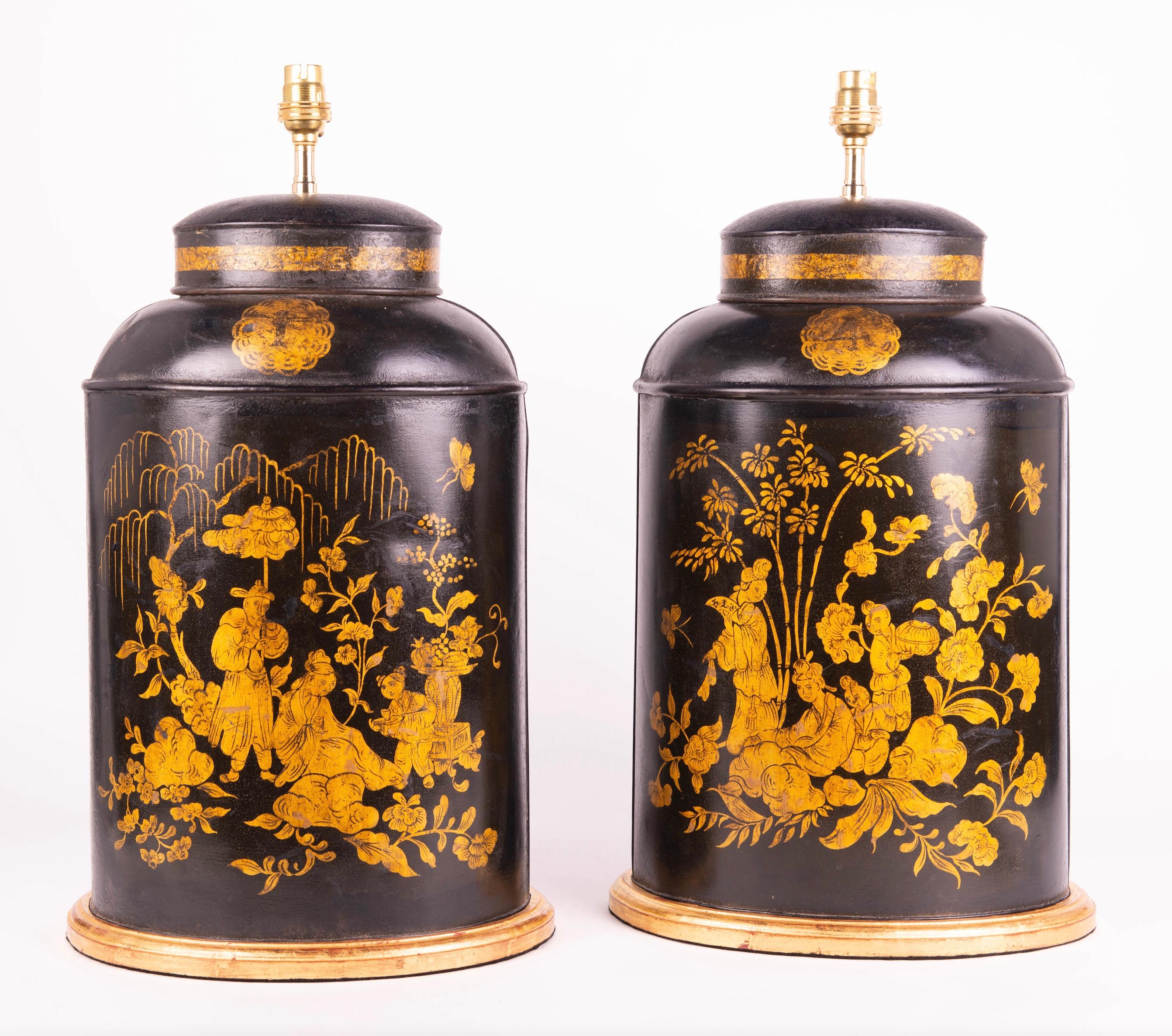 A fine pair of 19th century oval tole tea canisters by Bartlett & Co. of Bristol, decorated with gilded chinoiserie scenes on a black background, now mounted as lamps with a hand gilded turned bases.

Height of vase: 17 3/4 in (45 cm) including