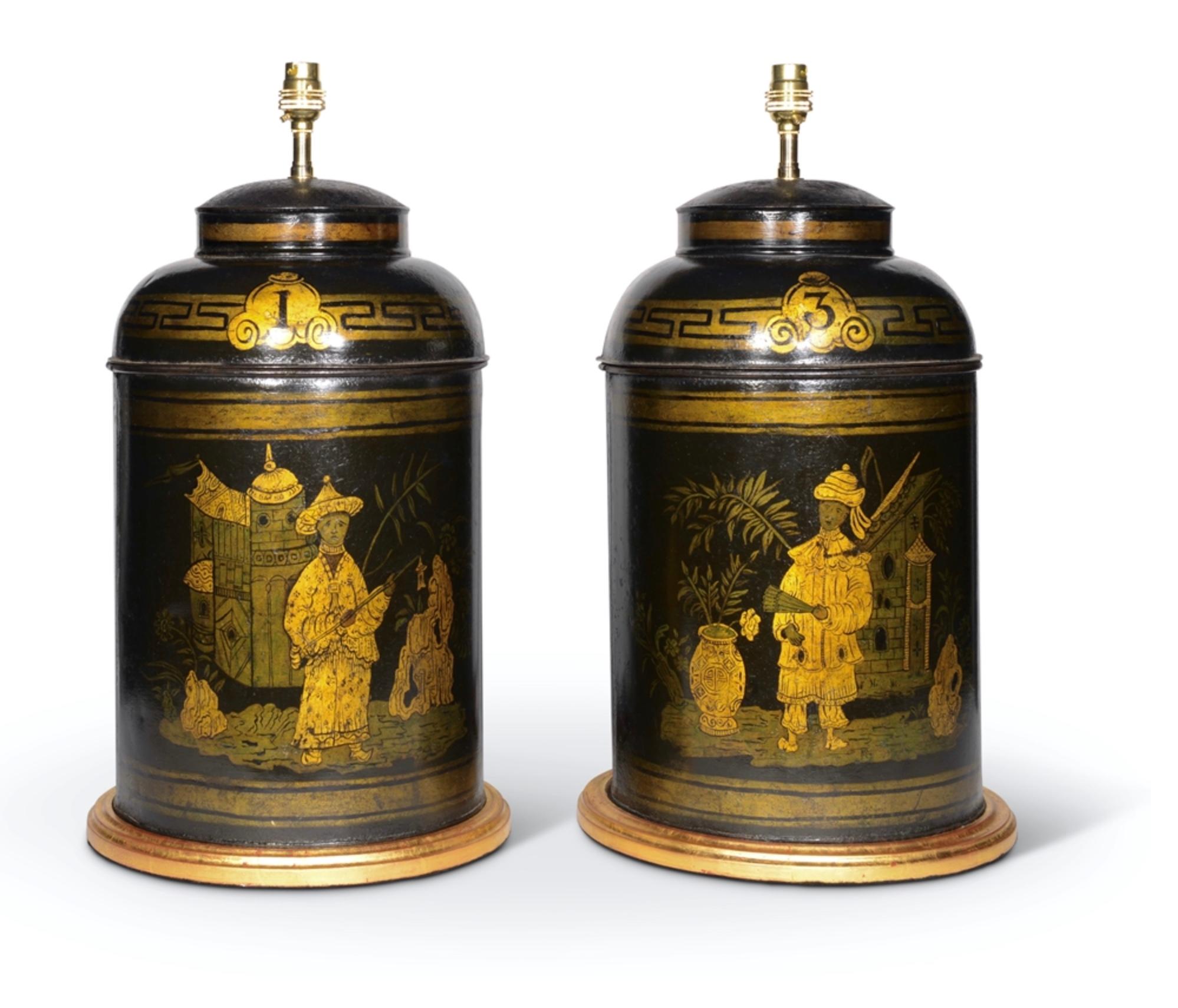 A fine pair of Regency period early 19th century lidded and numbered tole tea canisters decorated with chinoiserie figures and motifs in gilded highlights on a black japanned ground. Now mounted as lamps with hand gilded turned bases.

Height of
