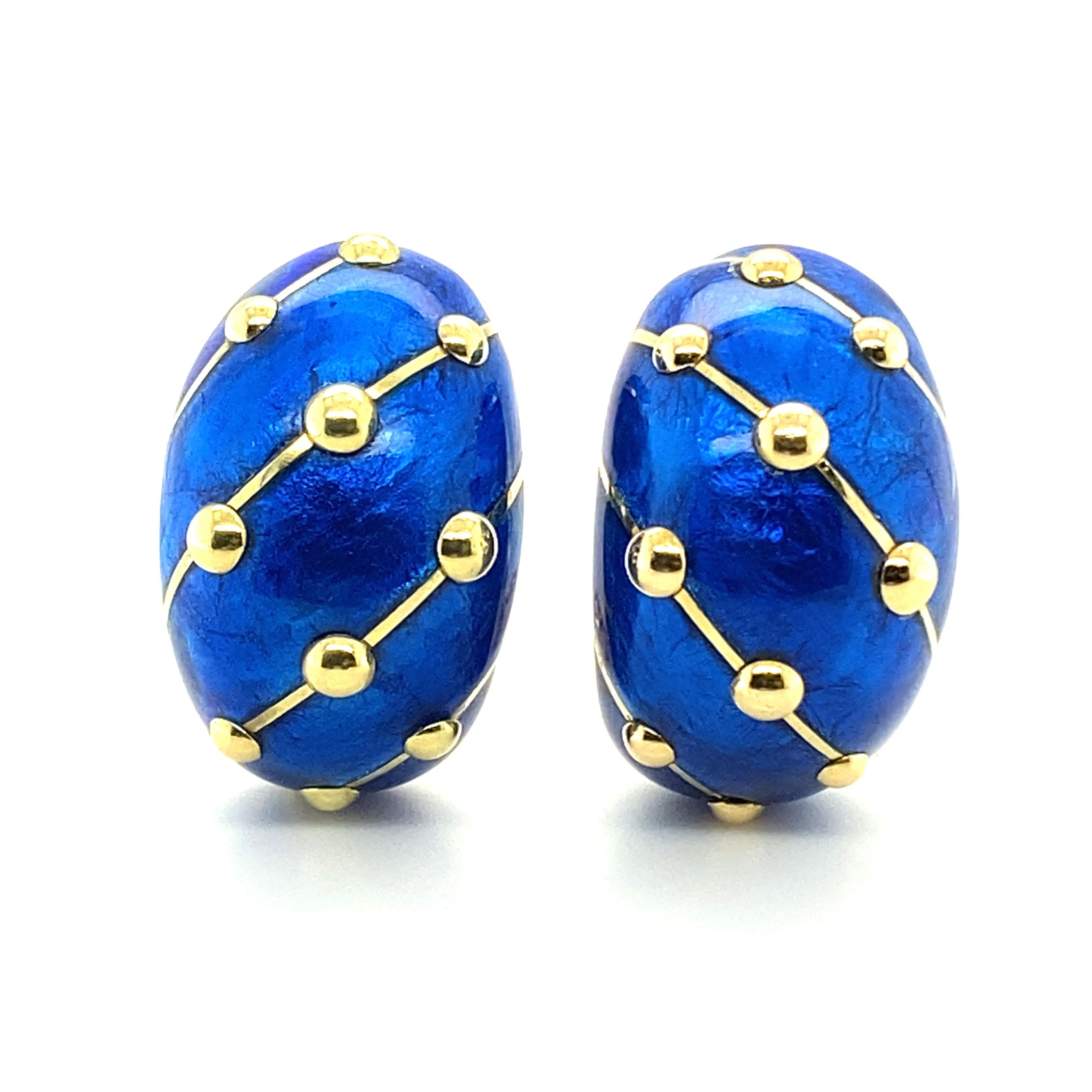 These beautiful earclips by the acclaimed French designer Jean Schlumberger are crafted in a luminous cobalt blue paillonné enamel and 18 karat yellow gold. Decorated with diagonal lines and three-dimensional dots in 18 karat yellow gold. A timeless