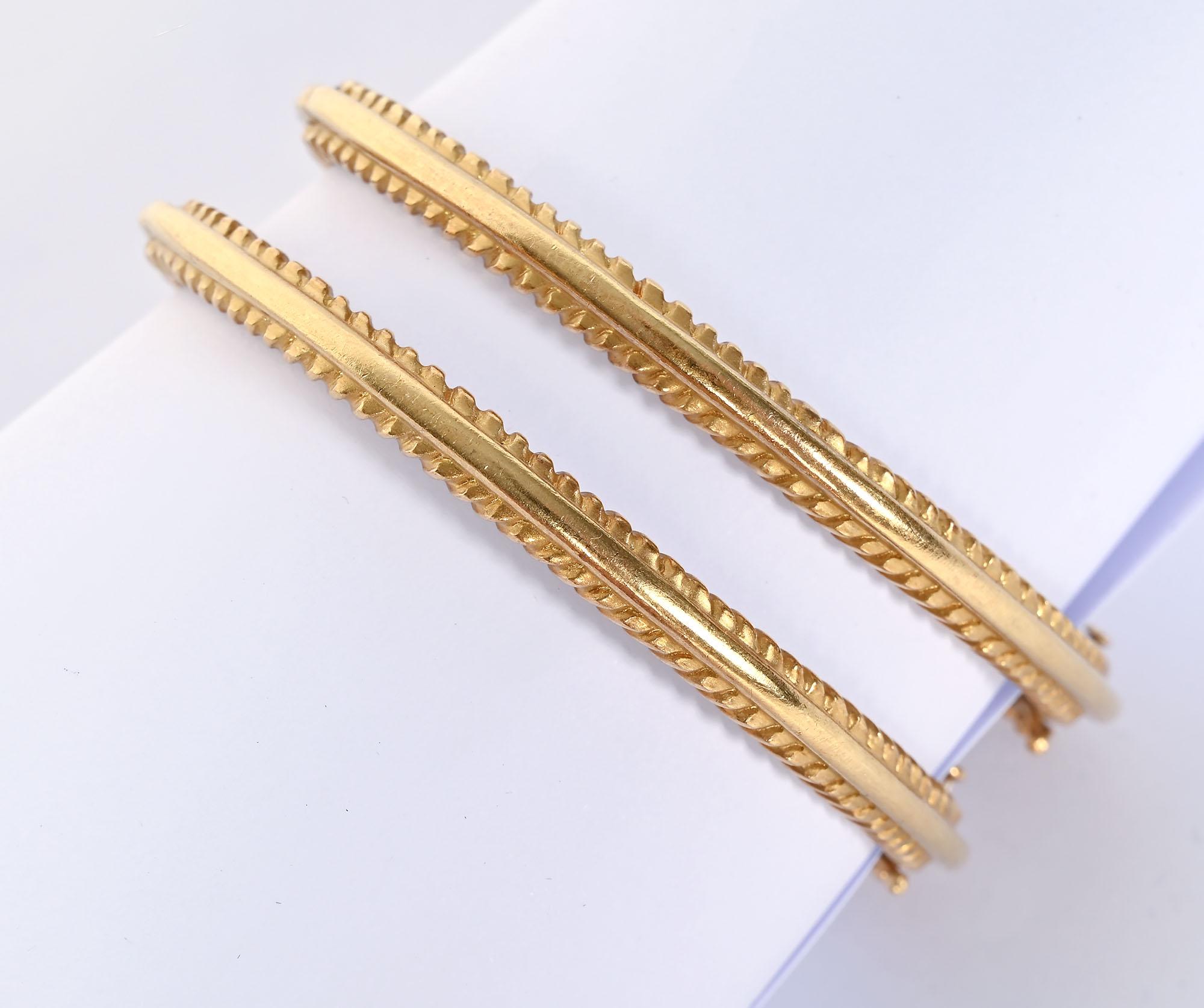 Pair of hinged gold and diamond bangle bracelets by Doris Panos. The bracelets are hinged. They have an inner diameter of 2 1/4 inches. They are 1/4 inch in height. Total diamond weght of each is about half a carat. The bracelets have a tongue clasp