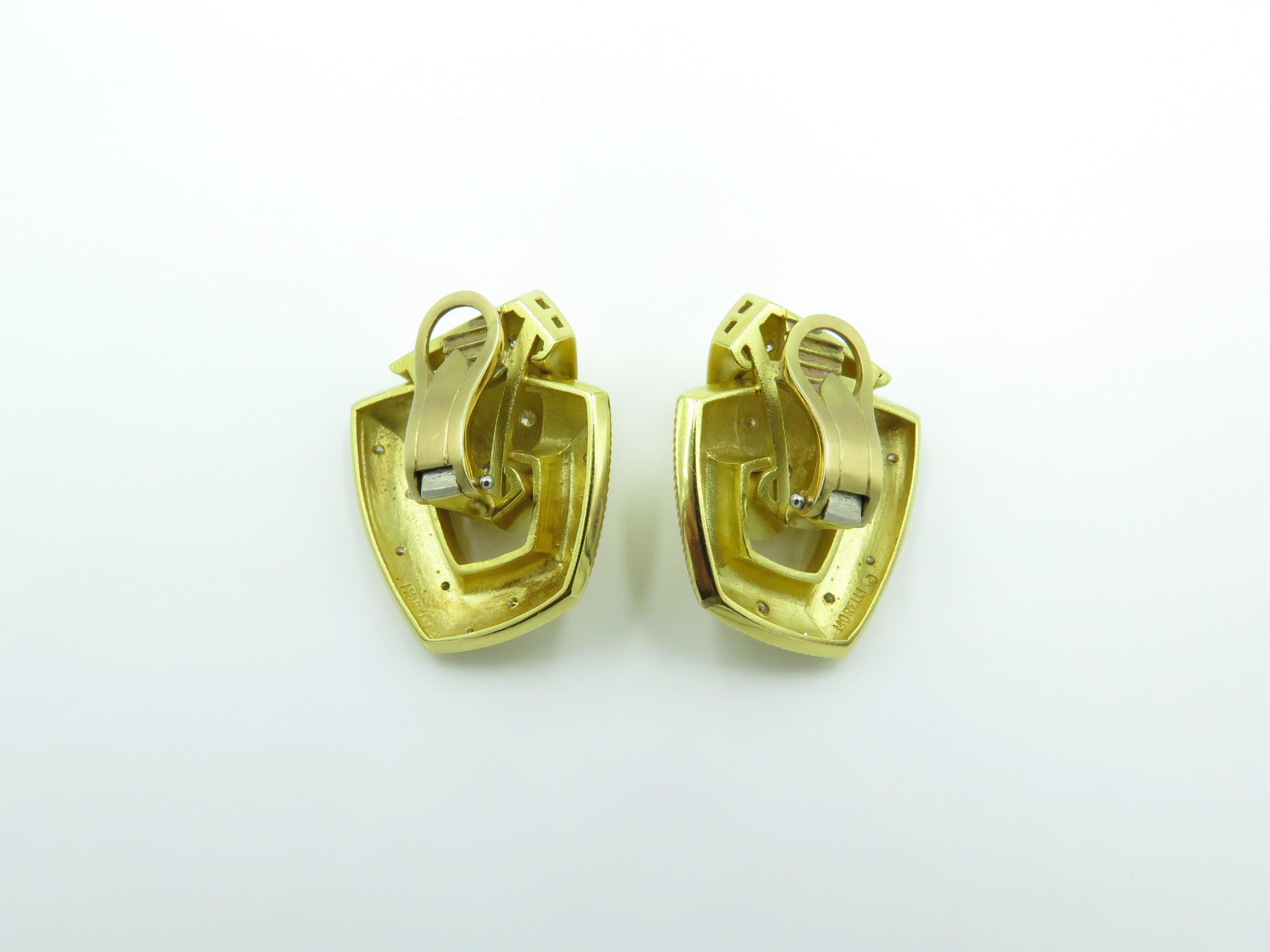 A pair of 18 karat yellow gold and diamond earrings. Of rigged door knocker design, enhanced by circular cut diamonds, thirty (30) diamonds weigh approximately 0.60 carat. Length is approximately  inch, gross weight is  approximately 27.7 grams. 