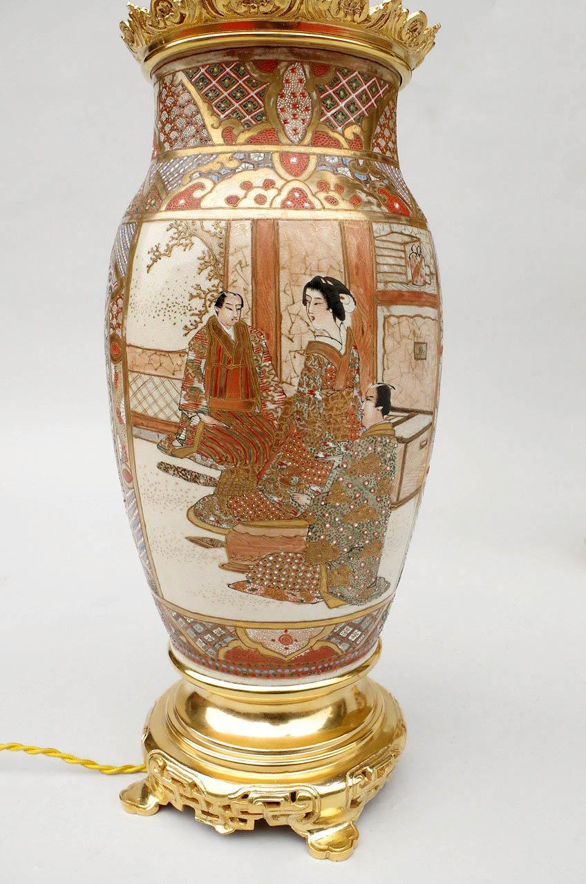 Pair of lamps composed of two ovoid ceramic vases decorated with polychrome enamels on a white background. Body adorned with large cartouches representing on one-side samurais on landscapes and on the other side, dignitaries on interior places.