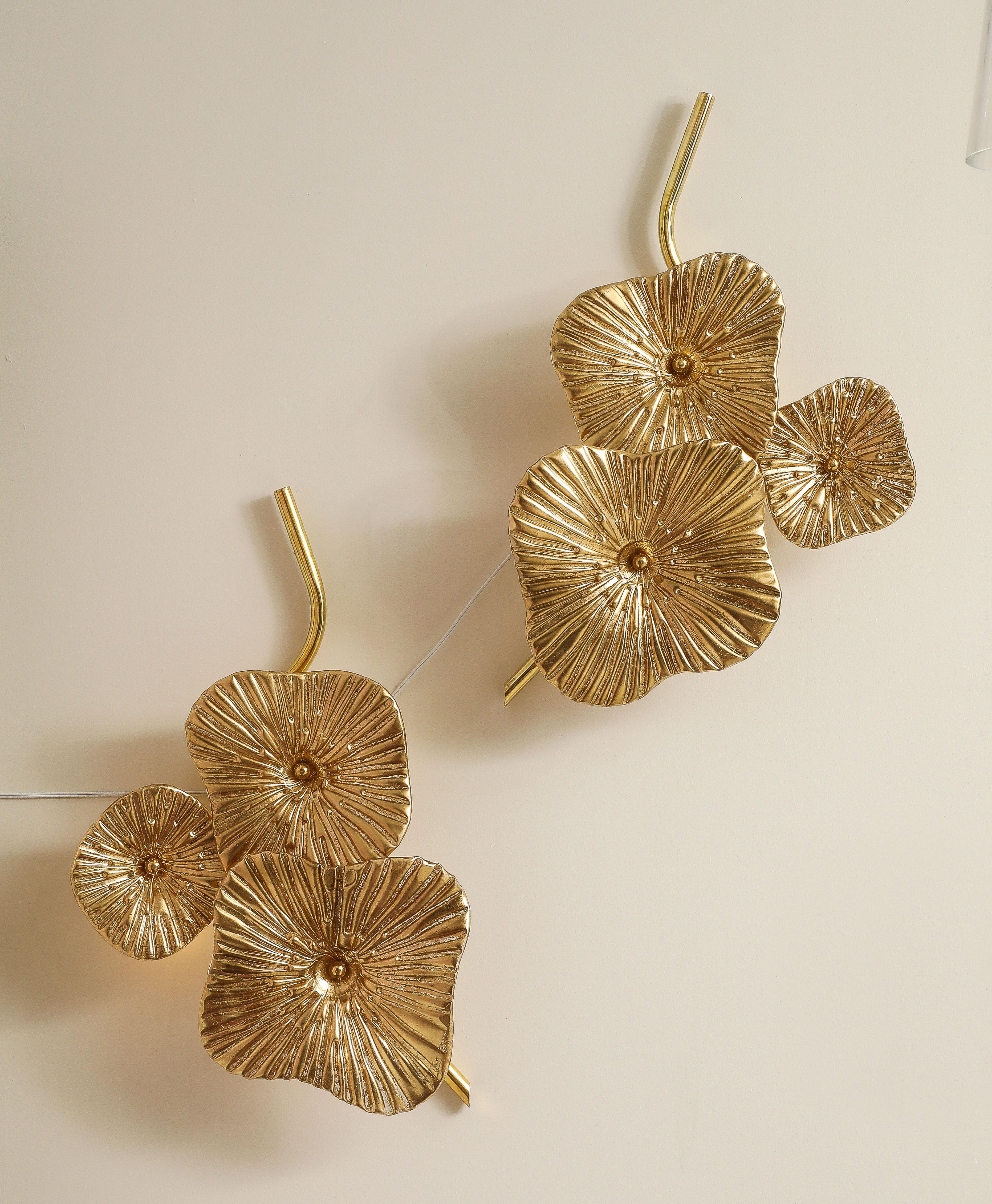Pair of gold bronze Murano Glass flower sconce or wall art with brass frame. Three hand-casted and formed Murano glass flowers with hand-applied, 24k gold leaf on reverse of glass are attached with a brass caps to brass stems.  The Murano glass