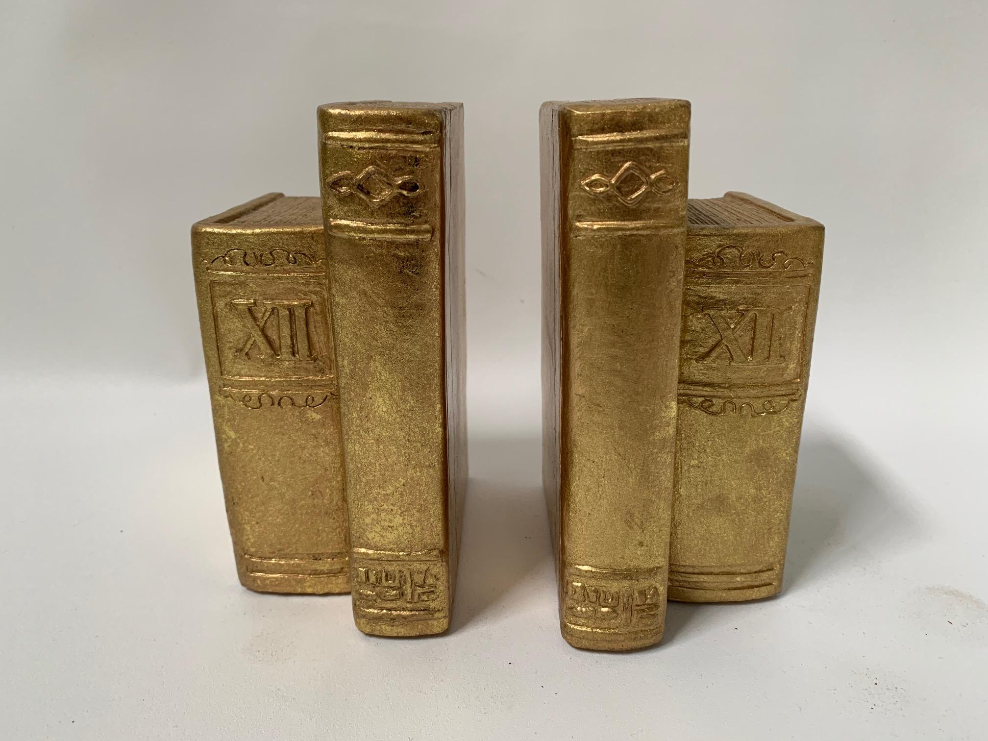Pair of bookends in the form of standing books finished in gold gilding. Great vintage condition.