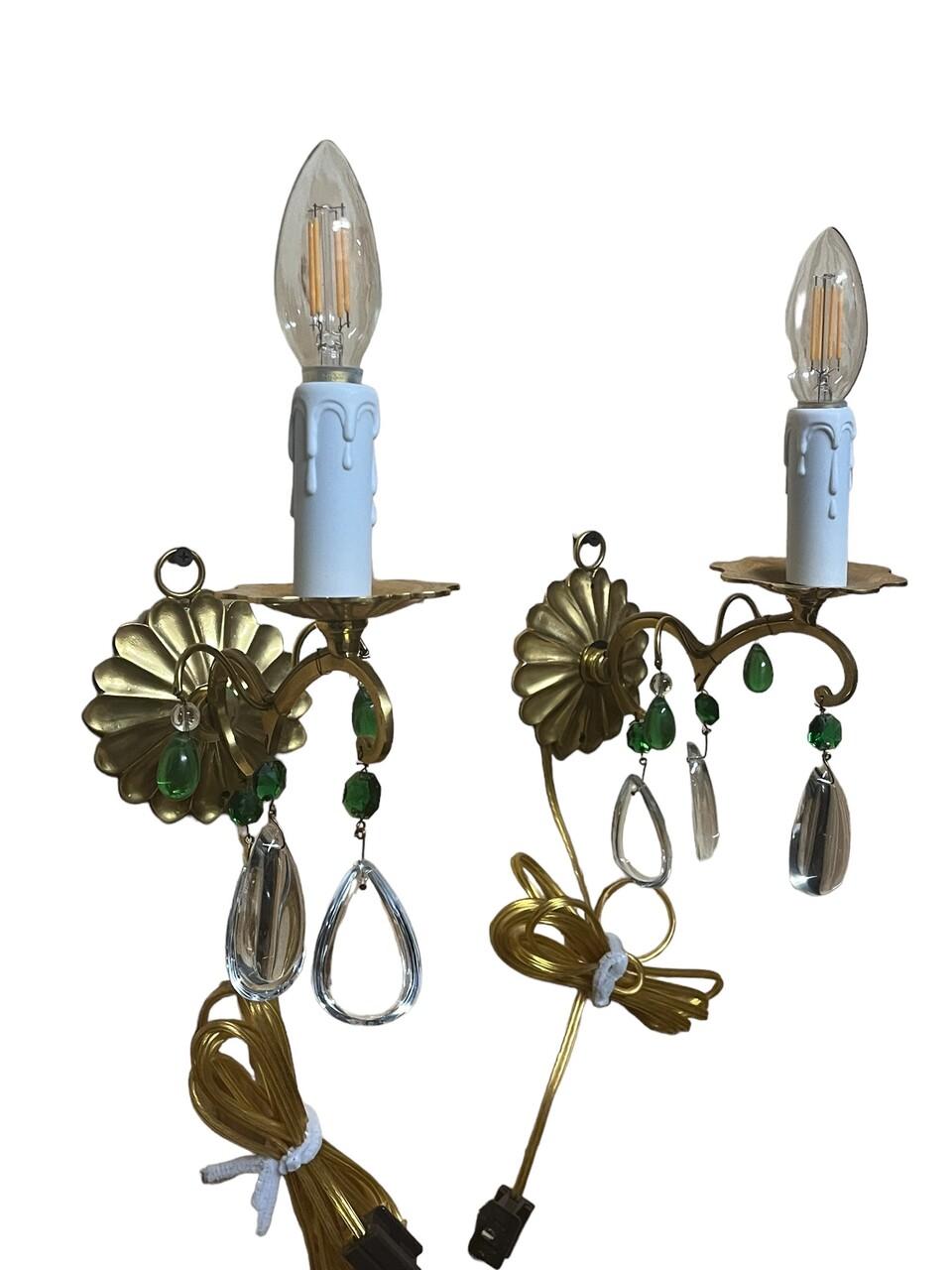 Pair of gilt metal wall sconces rosette back plates with green and clear crystals. Featuring new wiring.