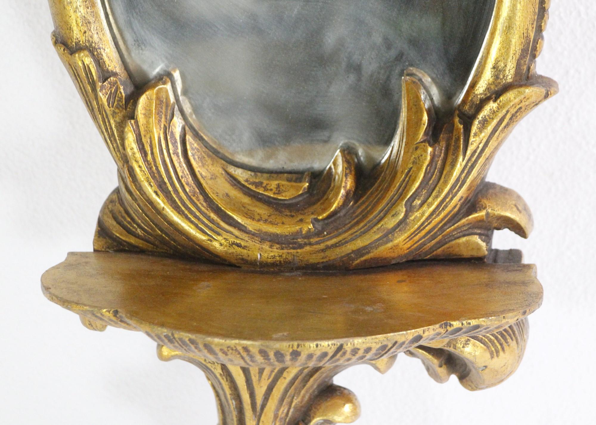 20ième siècle Paire de miroirs muraux en bois doré avec détails de feuillage et étagères en vente