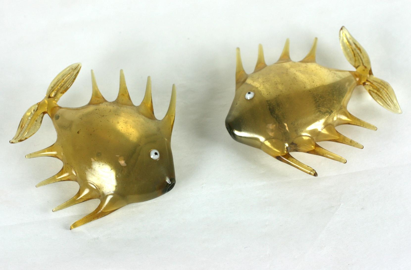 Delicate pair of gold glass Bimini fish from the 1930s Germany. Paper thin glass blown in the round (hollow) in an amusing cartoon design. We think these would work well in an aquarium or diorama. 
Approx. 2.75