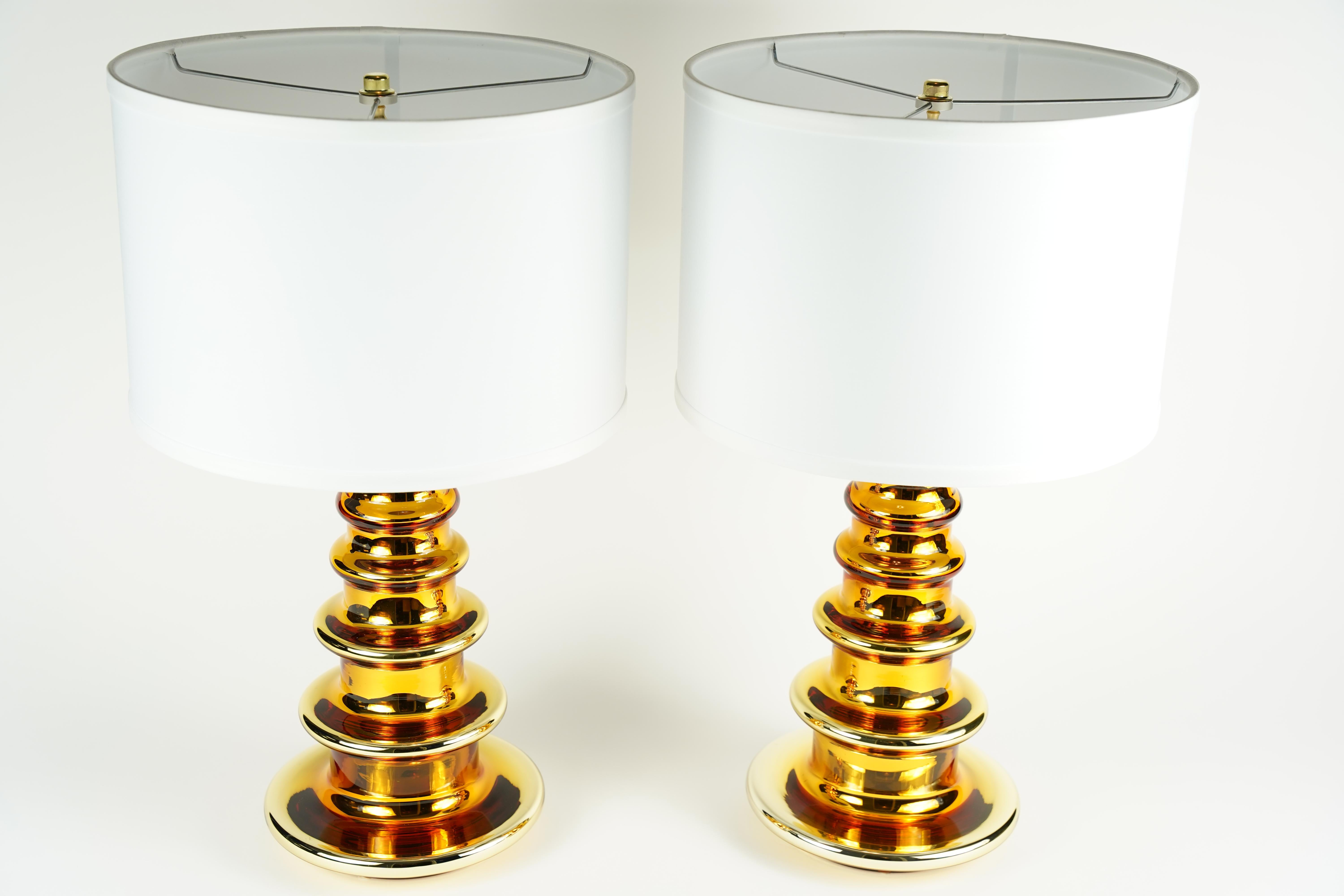 Pair of gold glass cased table lamps by Flygsfors, Sweden, 1970.
 
Rewired for the US.