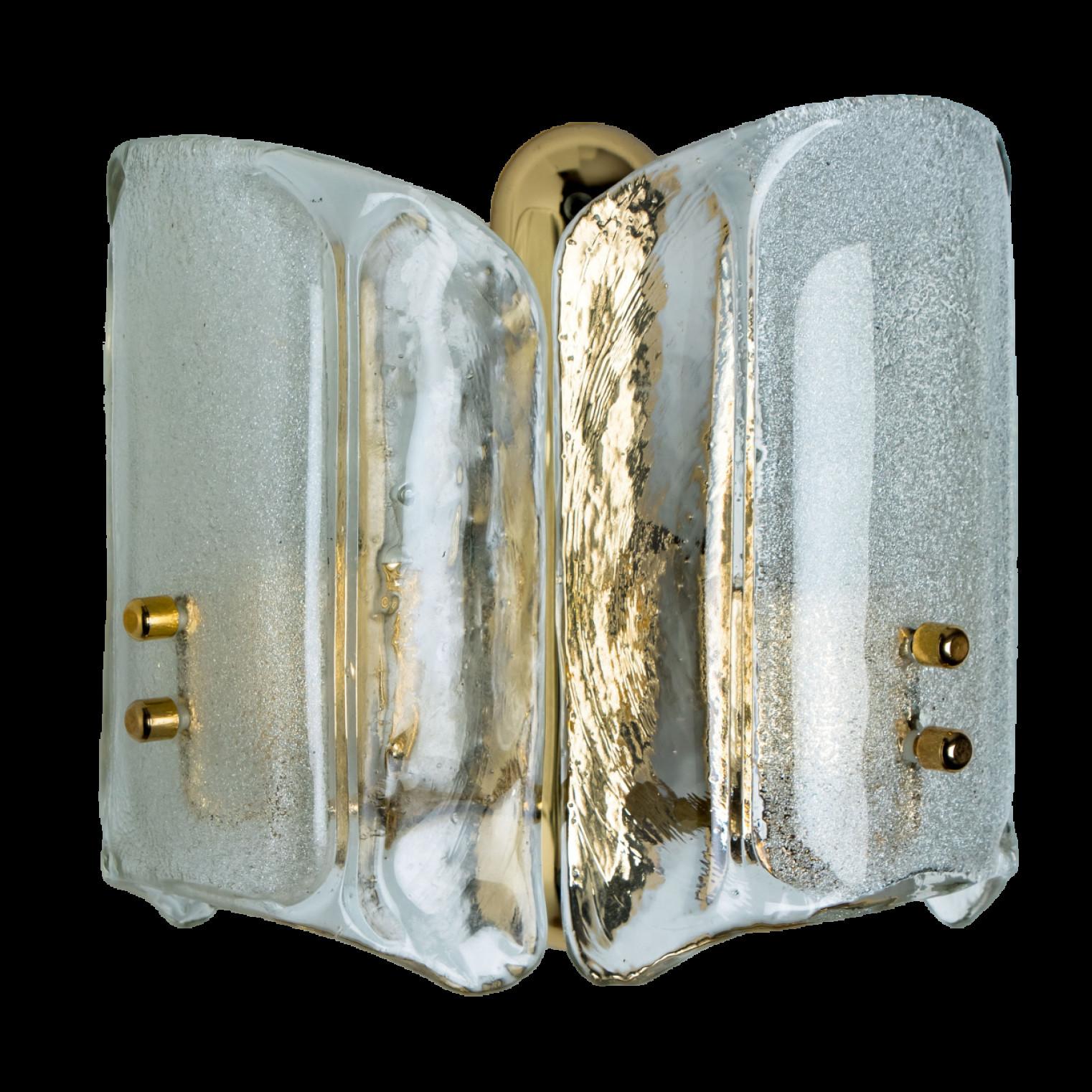 Pair of wall lights were designed in the style of Kalmar, featuring a square brass base and a rectangular glass cover in opal and clear glass.

Dimensions:
Height 9.84