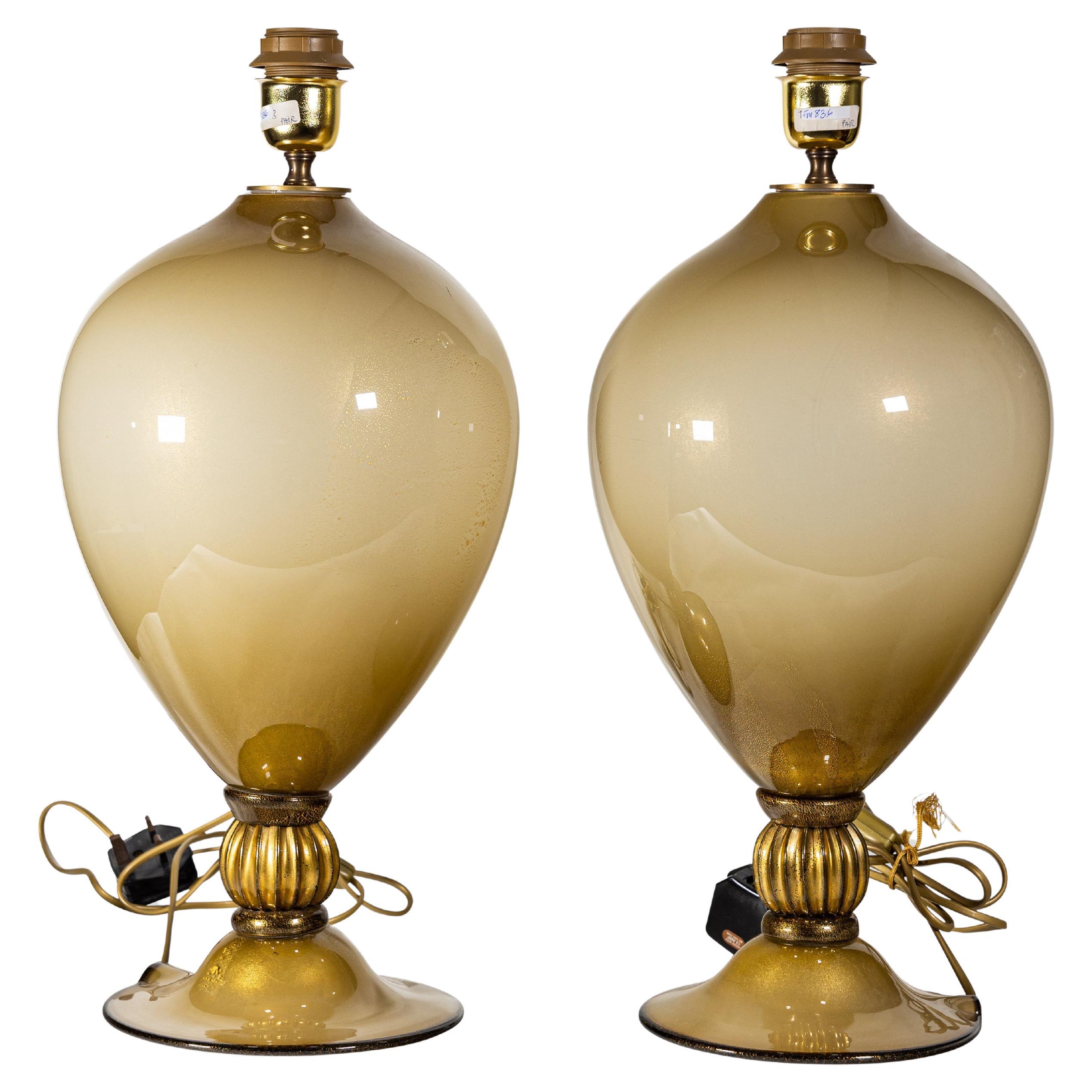 A pair of Veronese vase shaped blown glass table lights. Encased technique with gold inclusions, fume' gradually from sand to beige color.
Sold without the shade