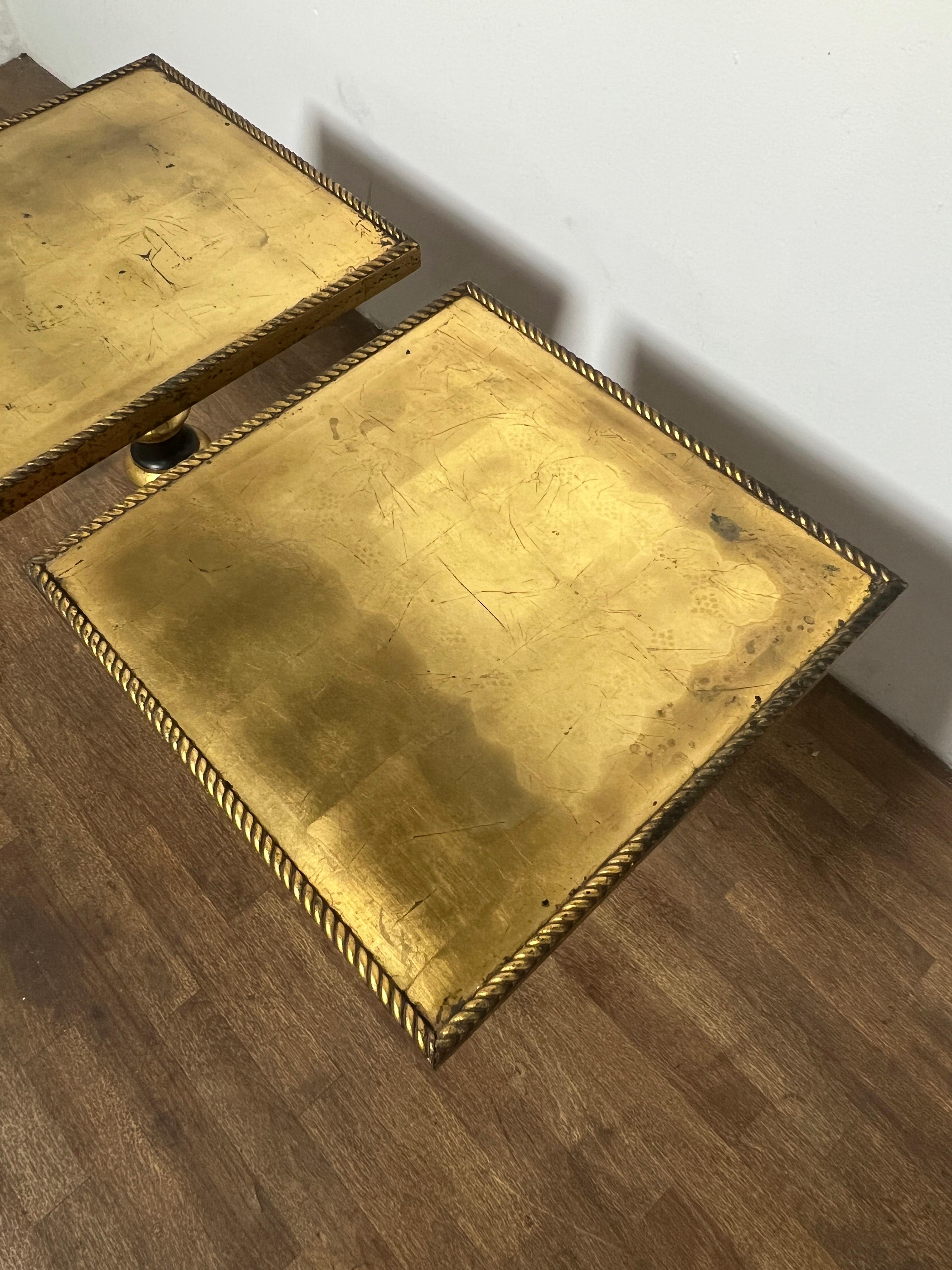  A pair of lacquered and gold leafed neoclassical side tables with braided molding, ca. 1960s.