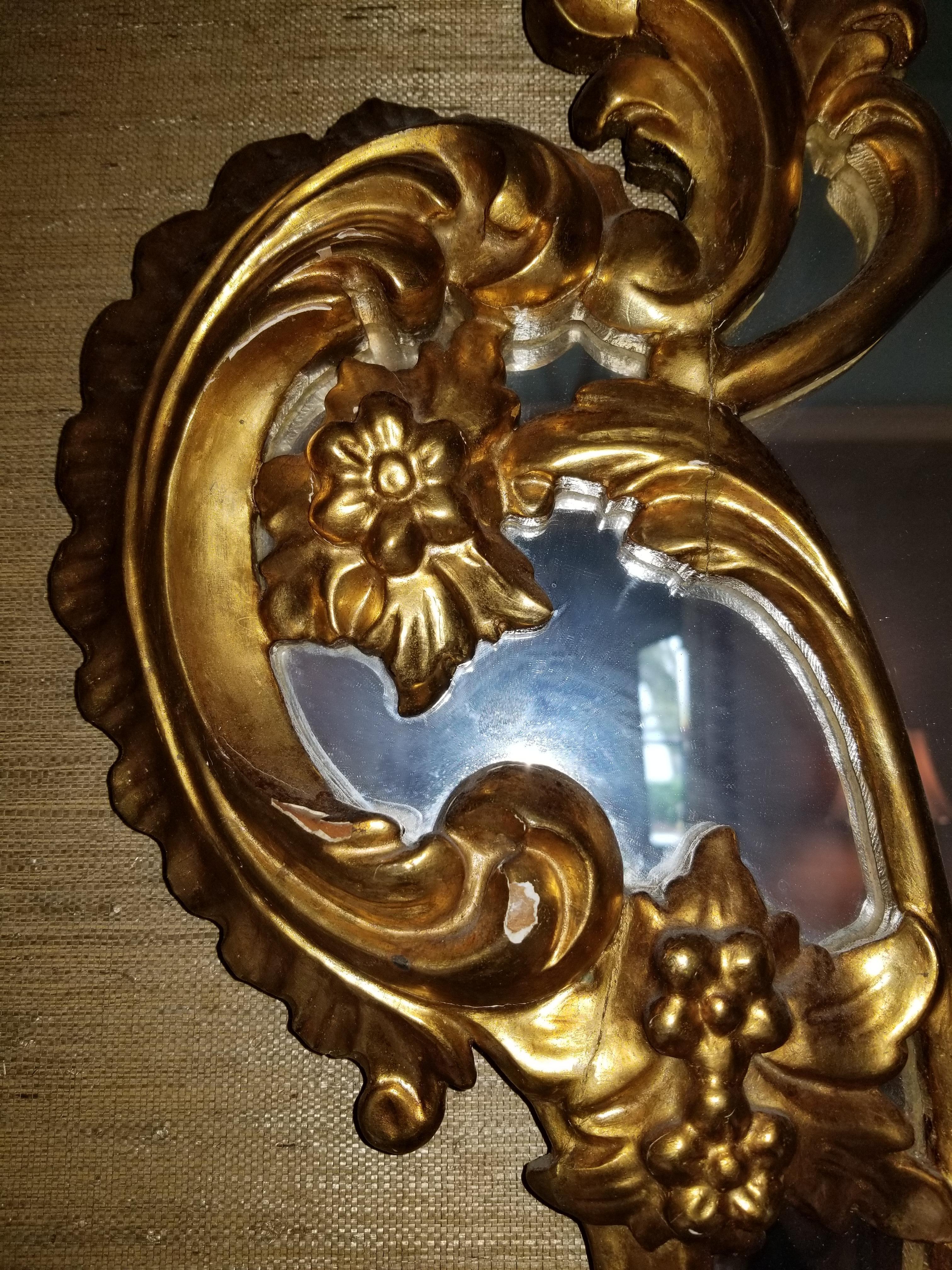 20th century pair of giltwood mirrors with a shell motif at top.
           