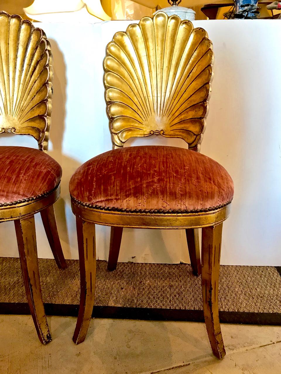 This is a great pair of iconic, circa 1950 Venetian gold leafed grotto chairs. The chairs are newly upholstered in a luxurious Italian blush-pink silk velvet. The chairs show natural patina to the gold leaf around the edges of frame, as shown in