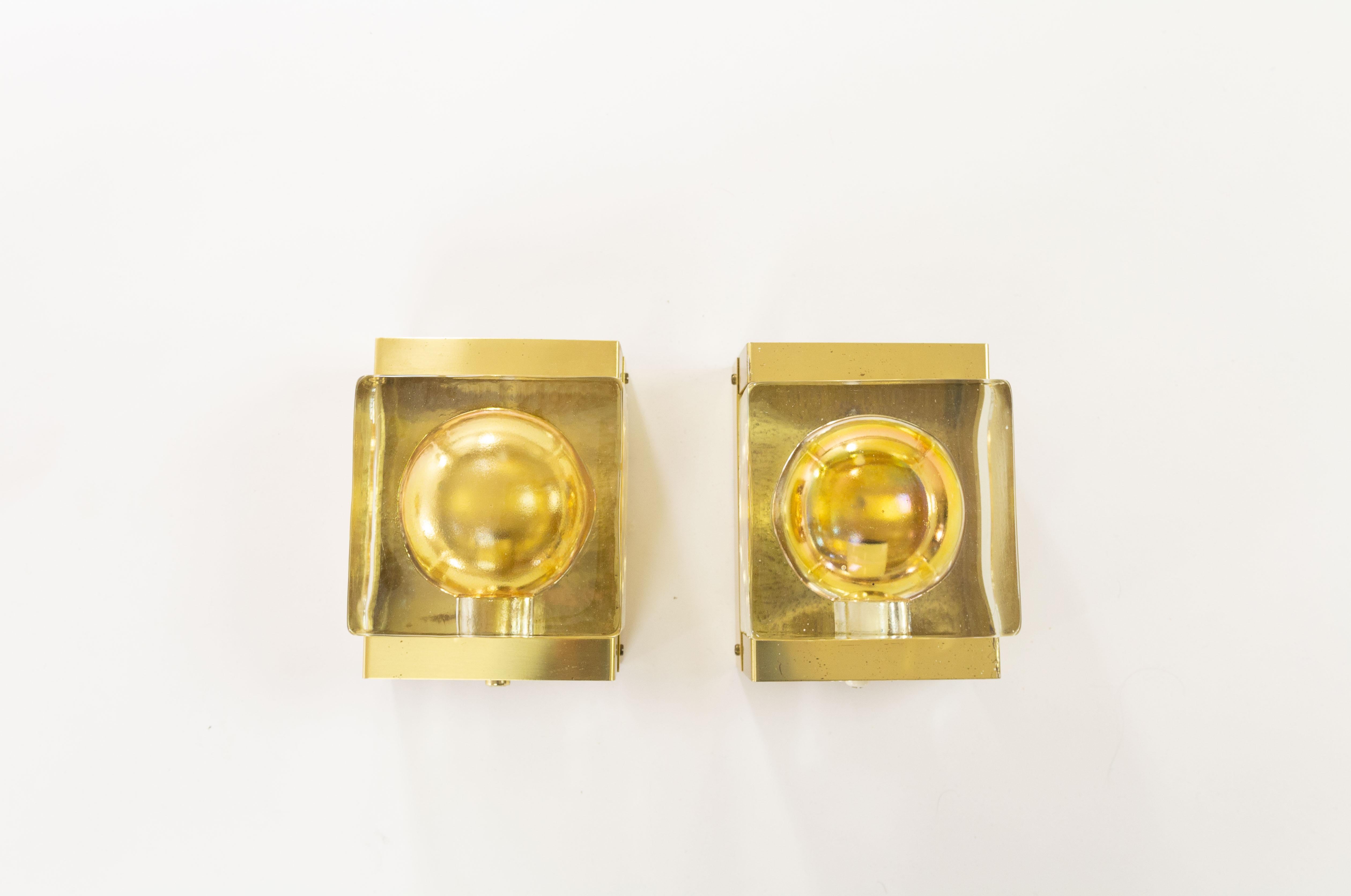 A set of two rare gold Maritim Lampet wall lamps, produced by Danish lighting manufacturer Vitrika in the 1970s.

Both lamps consist of two parts: a solid and so rather heavy handmade glass body (2.4 kg / 5.3 lbs) and the brass holder.

Price is