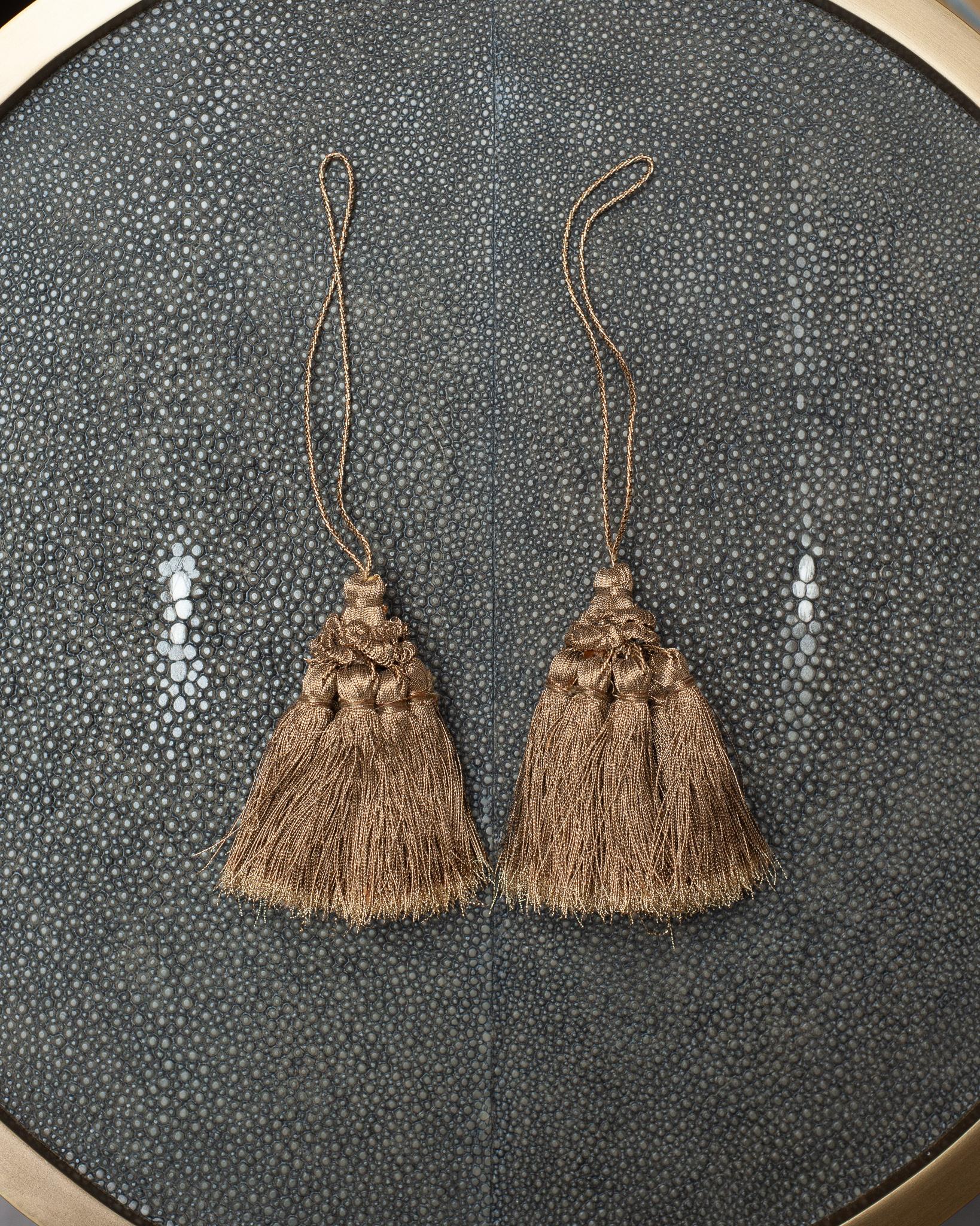A beautiful pair of metallic silk tassels, from Bevilacqua Italy. Established by Luigi Bevilacqua, and operating out of Venice since 1875, Bevilacqua Tessuti produces the most exquisite handwoven fabrics available out of Europe following ancient