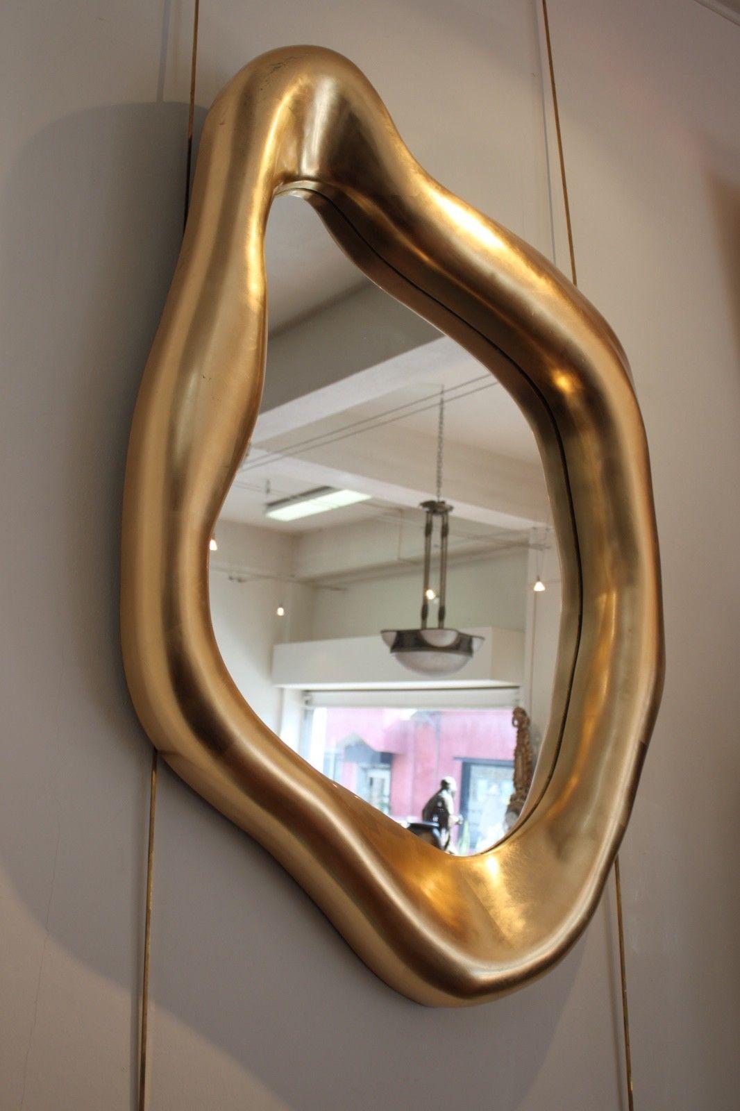 Pair of freeform gold mirrors. 
Very decorative.
Dimensions:
 H 119 x W 75 x D 9 centimeters 
 H 117 x W 68 x D 9 centimeters.
 