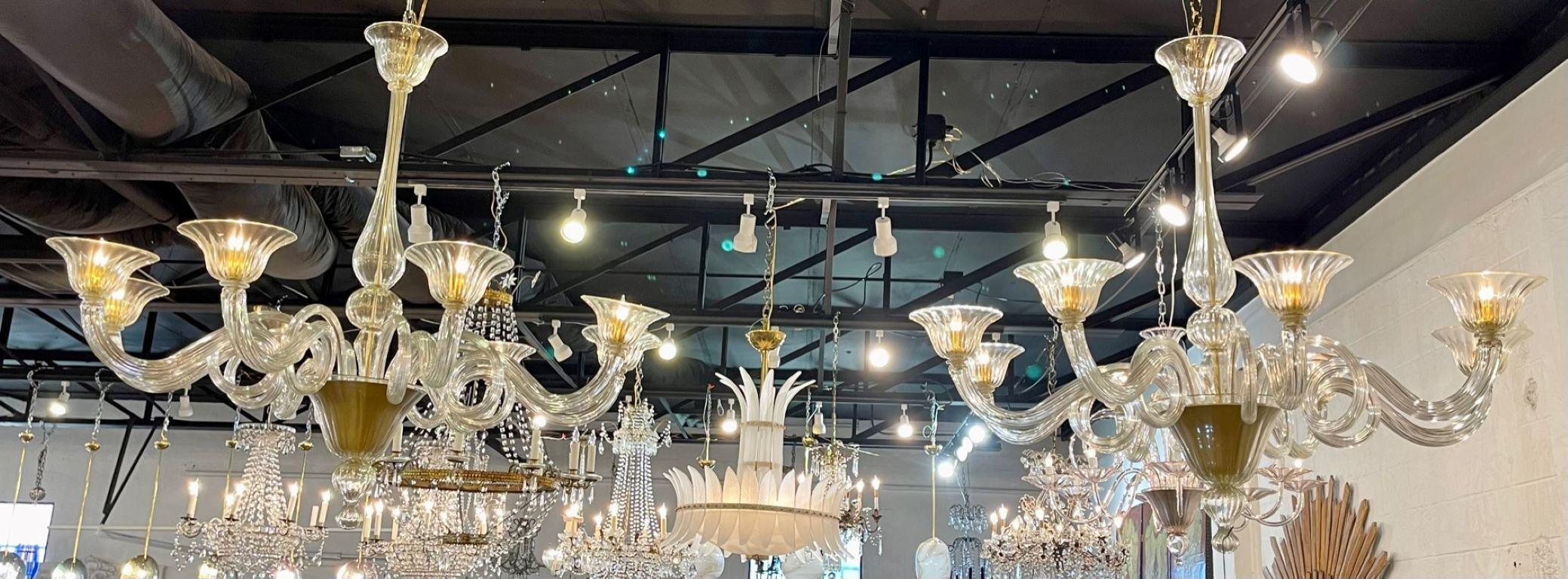 Gorgeous pair of Modern gold Murano glass chandeliers. Beautiful glistening glass and curly-que arms. These are extra special and a real work of art!