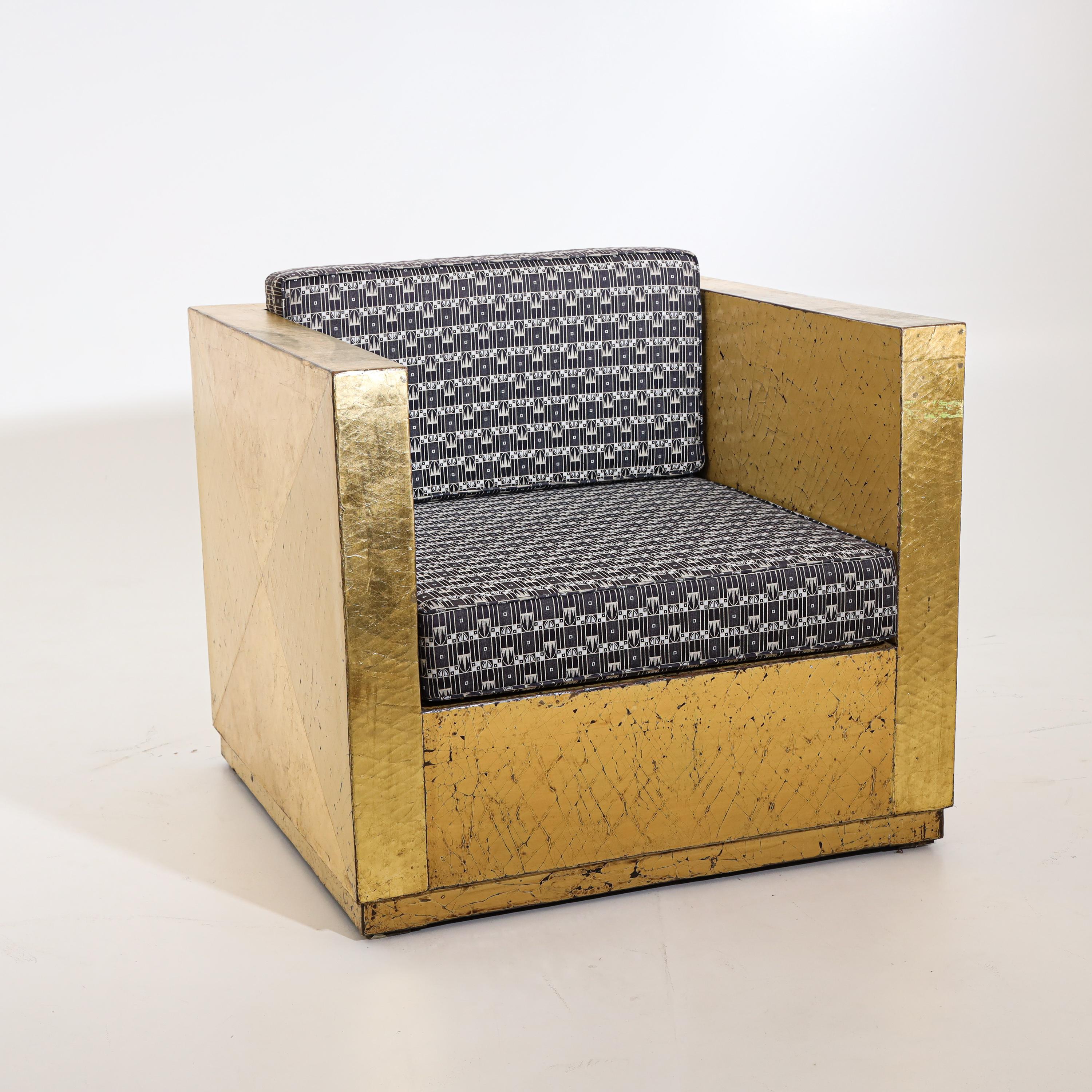 Pair of armchairs with gold patinated frame, straight armrests and seat cushions in Art Deco style. Very nice patina and geometrically constructed design on the sides, worn in places.
  