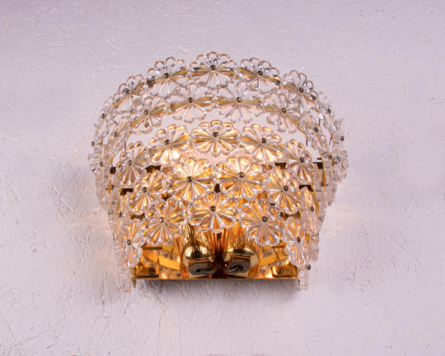 Beautiful pair of large gold-plated wall sconces with crystal glass flowers on a brass frame. Designed by Emil Stejnar for Rupert Nikoll, Vienna in the 1950s. 
 
Designer: Emil Stejnar attr. 
Manufacturer: Rupert Nikoll, Vienna attr. 
Measures: