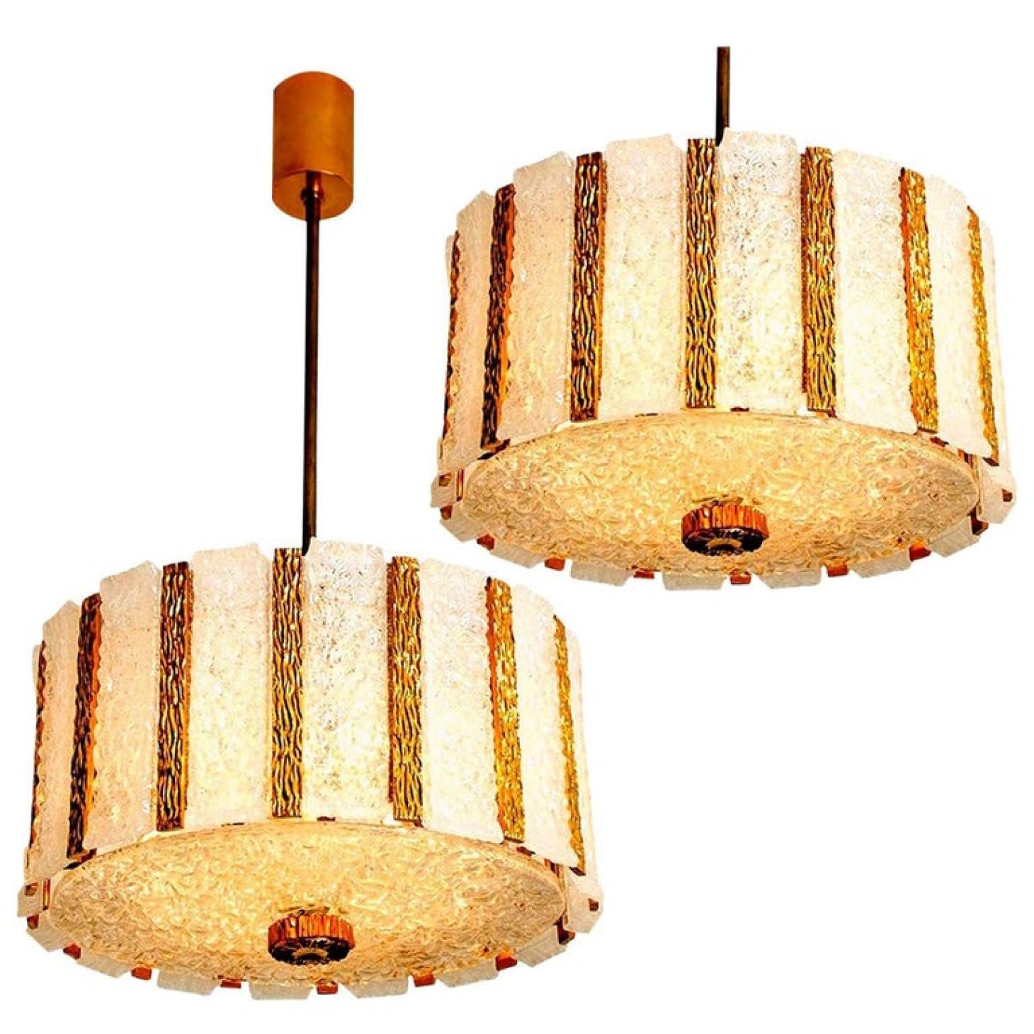Pair of gold-plated bronze drum light fixtures with several glass panels. This pair is executed to a very high standard. A part is rare to find.

The stylish elegance of this set suits many environment, from midcentury to Hollywood Regency, from