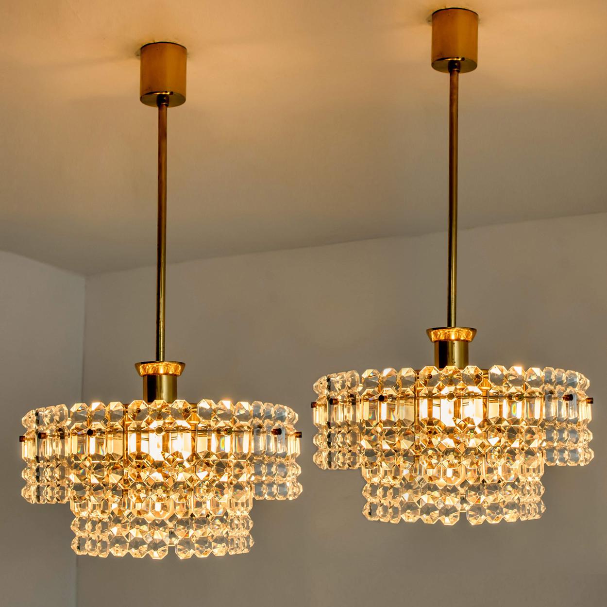 This modernist design chandeliers where designed by the Kinkeldey design team during the 1970s, and manufactured in Germany. A handmade and high quality piece. A pair is rare to find.

The small crystals are meticulously cut in such a way that the