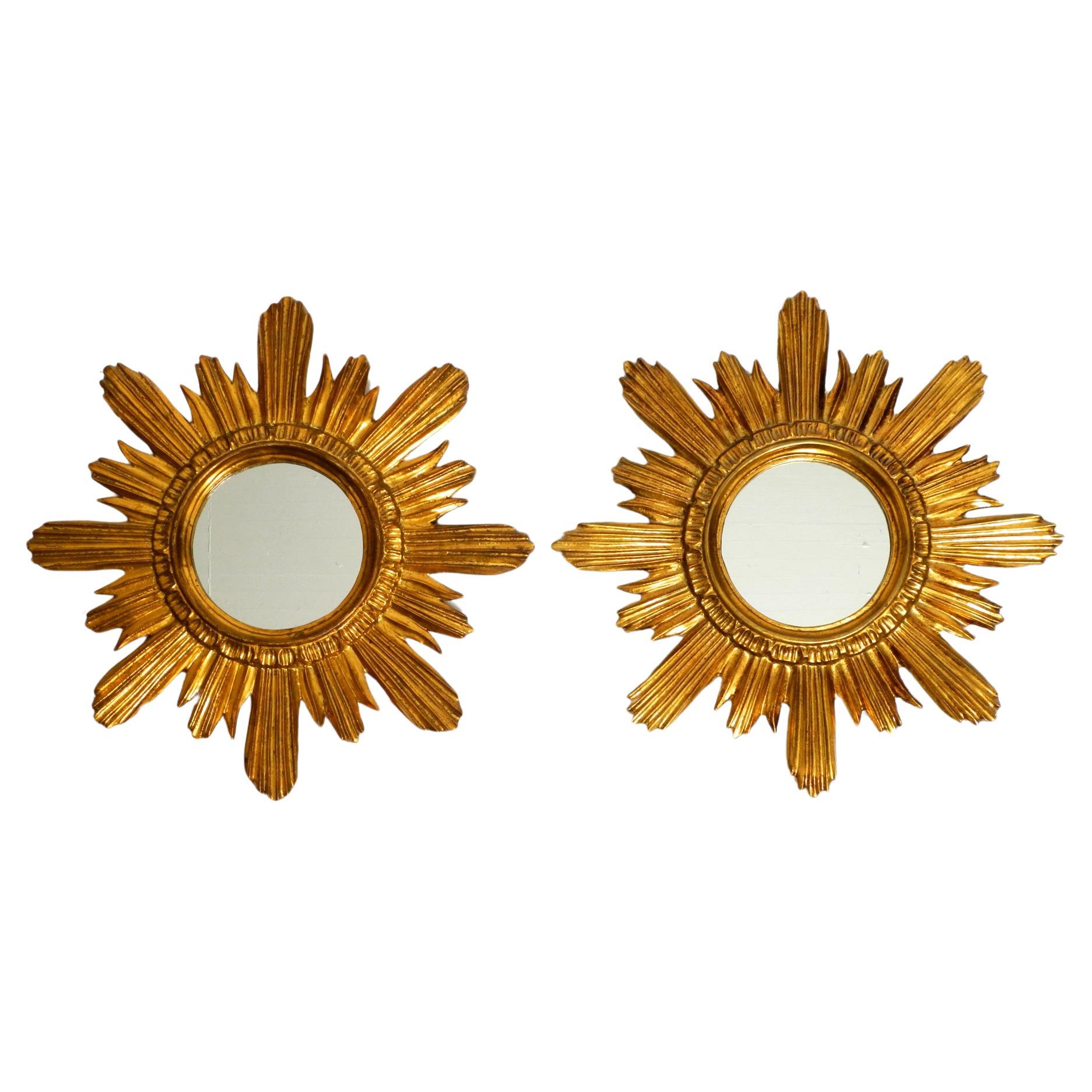 Pair of gold-plated mid-century sunburst wall mirrors made of wood and resin For Sale