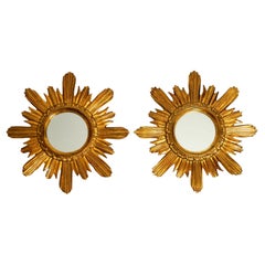 Pair of gold-plated mid-century sunburst wall mirrors made of wood and resin
