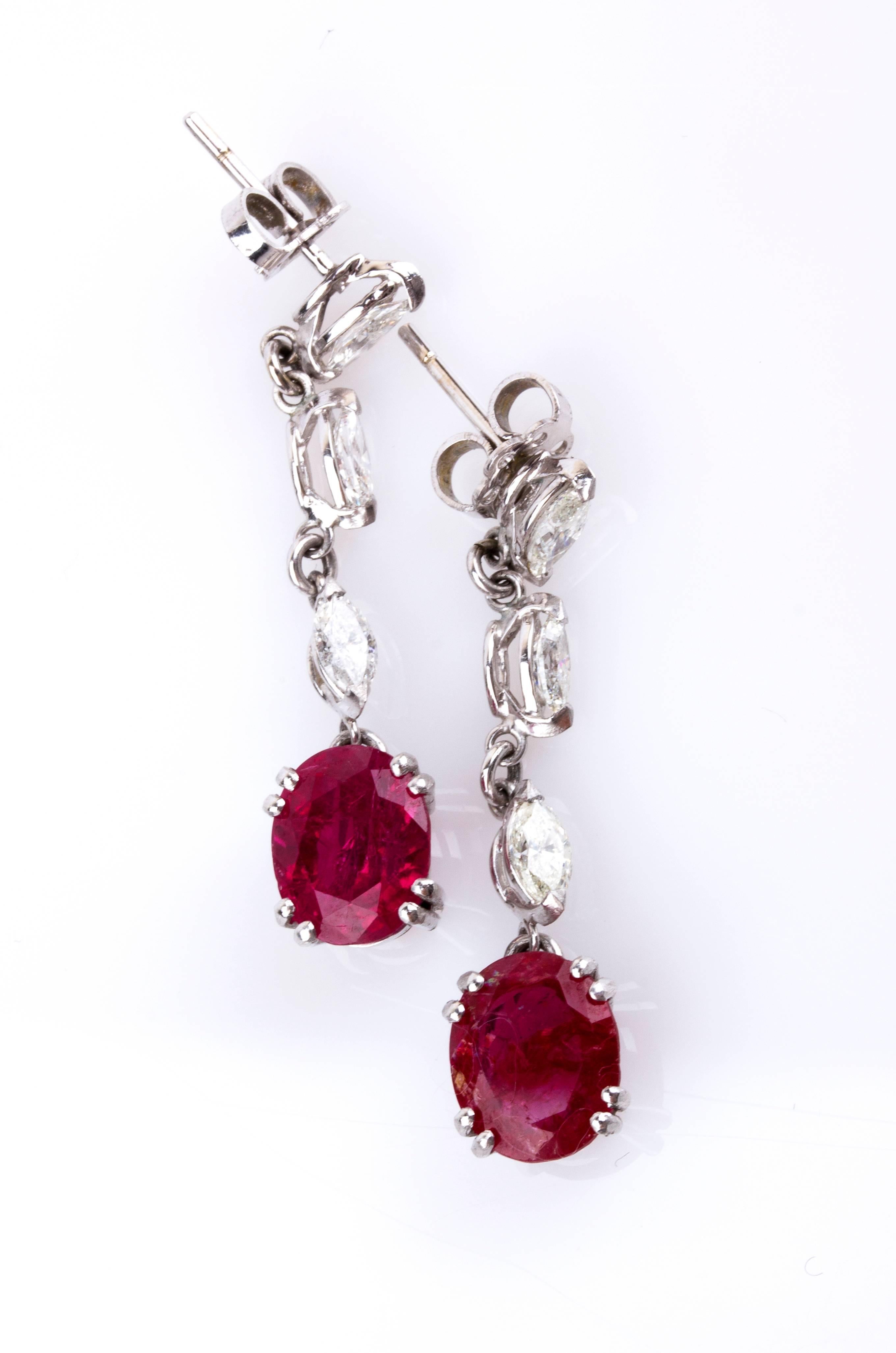2 rubies total weighing 5.32 ct, each decorated by a line of three marquise shape diamonds weighing ct, H-I color, VS-SI clarity. Lenght 37 mm. Weight 5.61 gr. Italian assay mark 750. Accompanied by Masterstones report no. 317CT108 dated 18th of