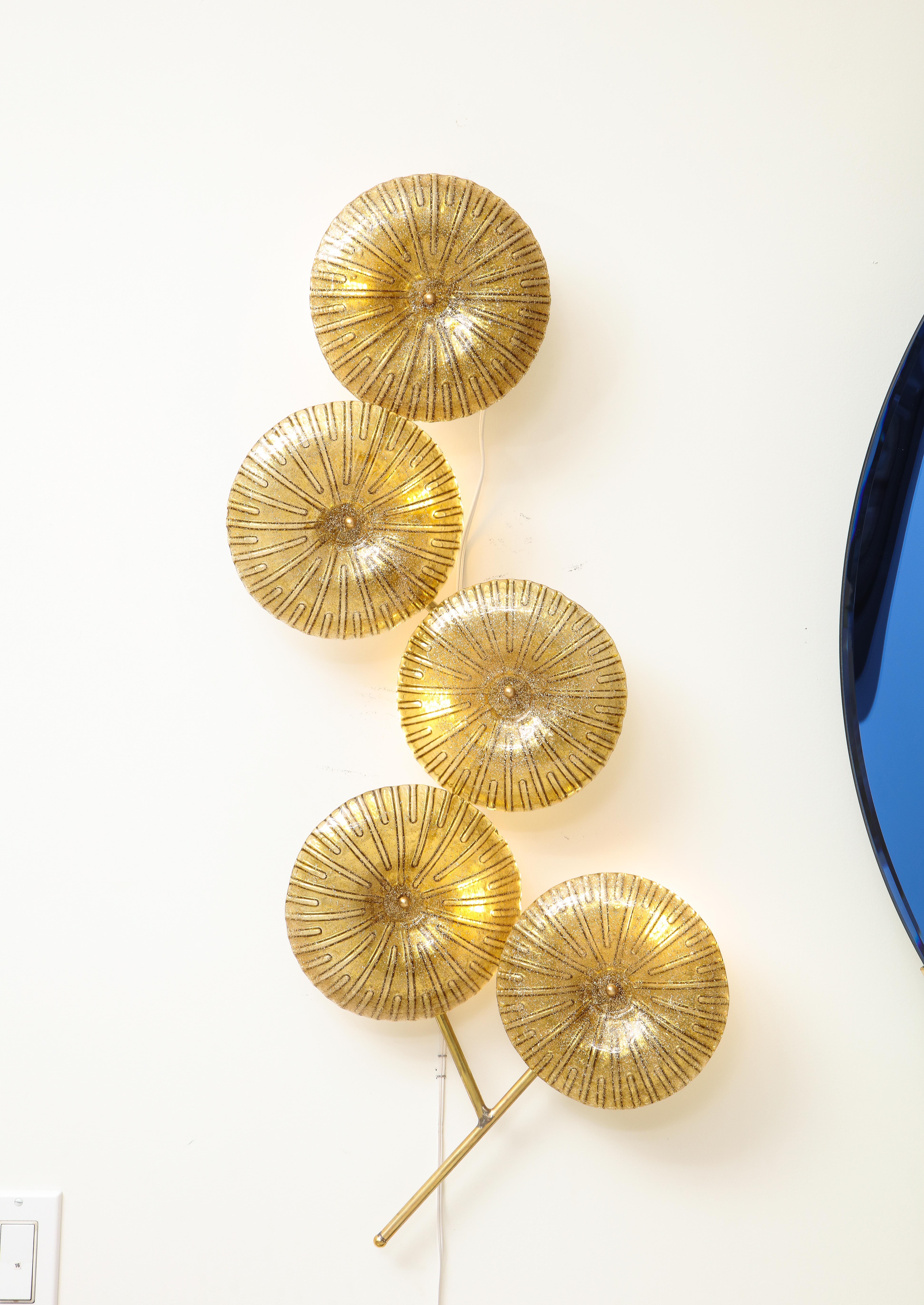Unique pair of Gold Shimmer Murano glass flowers with brass frame. Hand-casted Murano glass flowers in gold with infused gold flecks are attached with a brass cap to a brass stem. 5 glass 