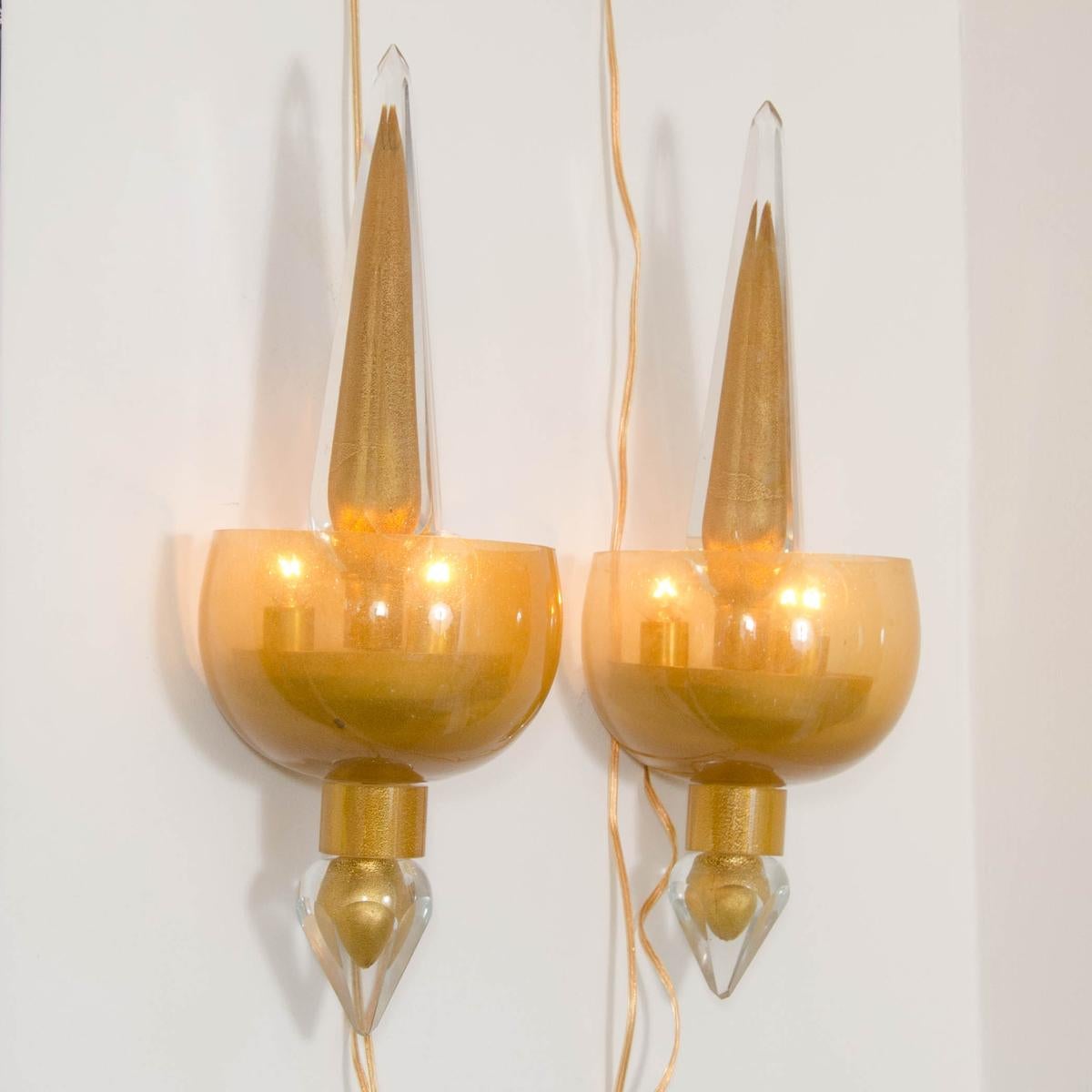 Pair of golden amber glass sconces .