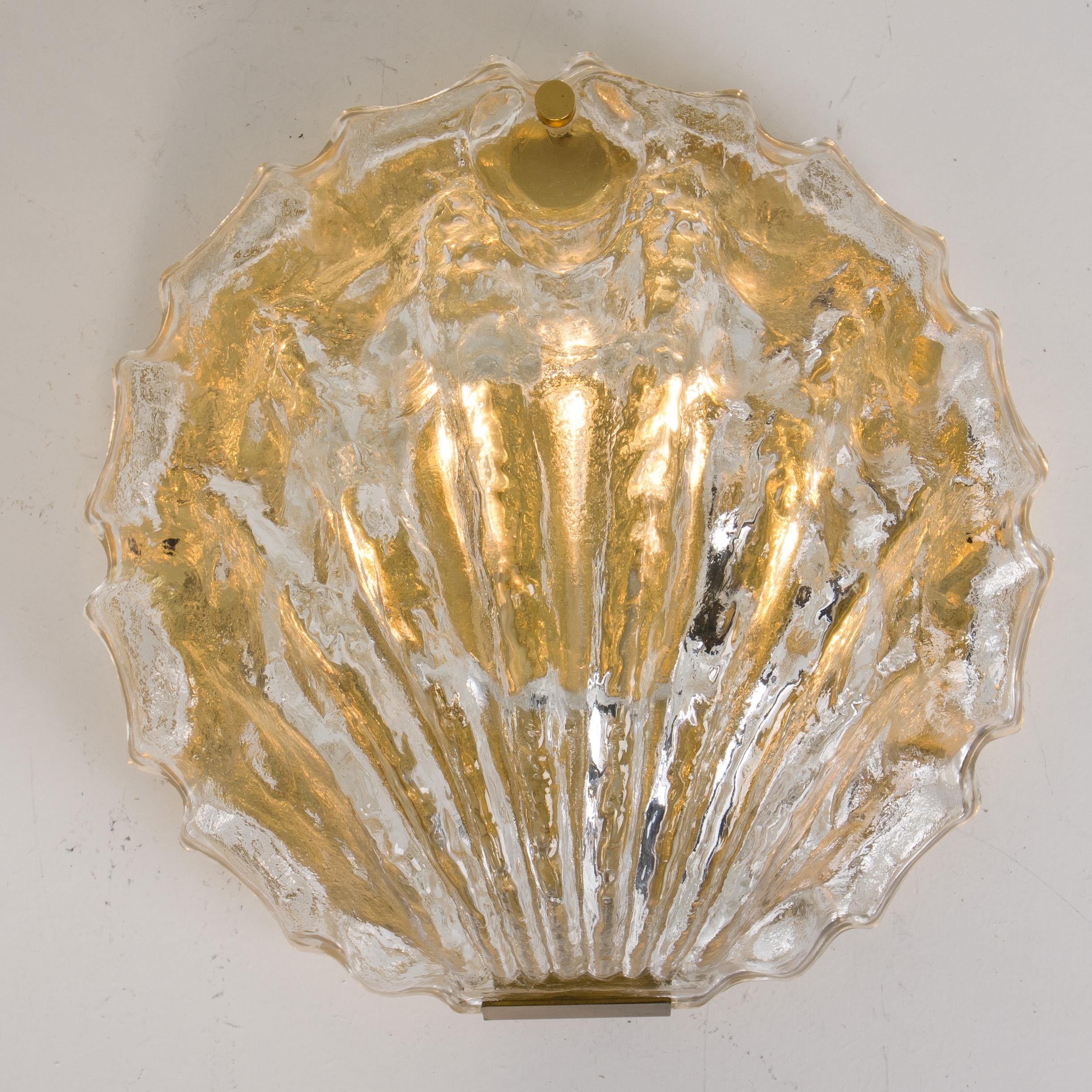 Pair of very exclusive wall lights by J.T. Kalmar handmade and very heavy quality. Each sconce is made of polished brass frames with a large crystal glasses in the form of a shell. Illuminates beautifully.

Please notice the price is for
