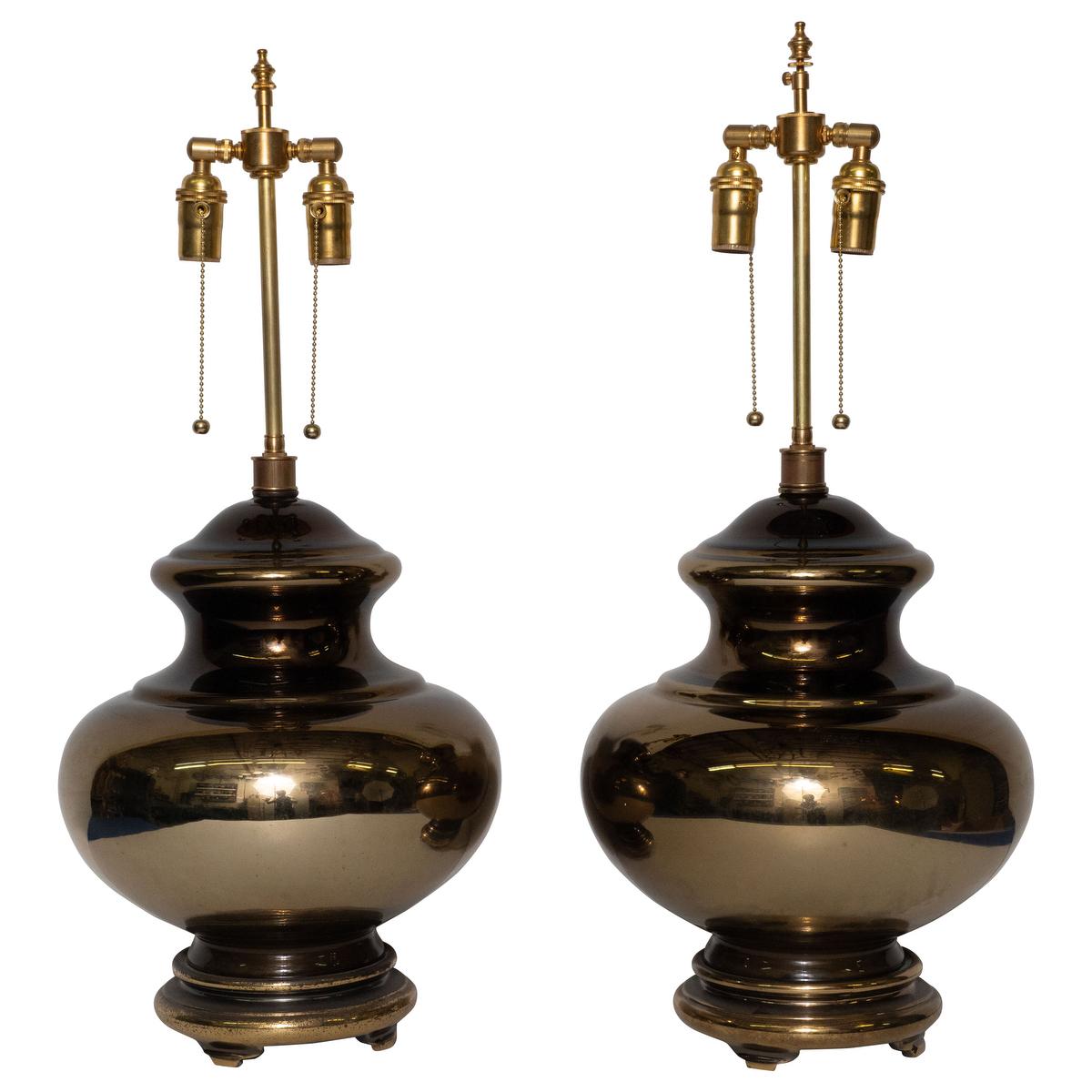 Pair of glass urn-shaped table lamps with golden mercury finish and brass hardware.