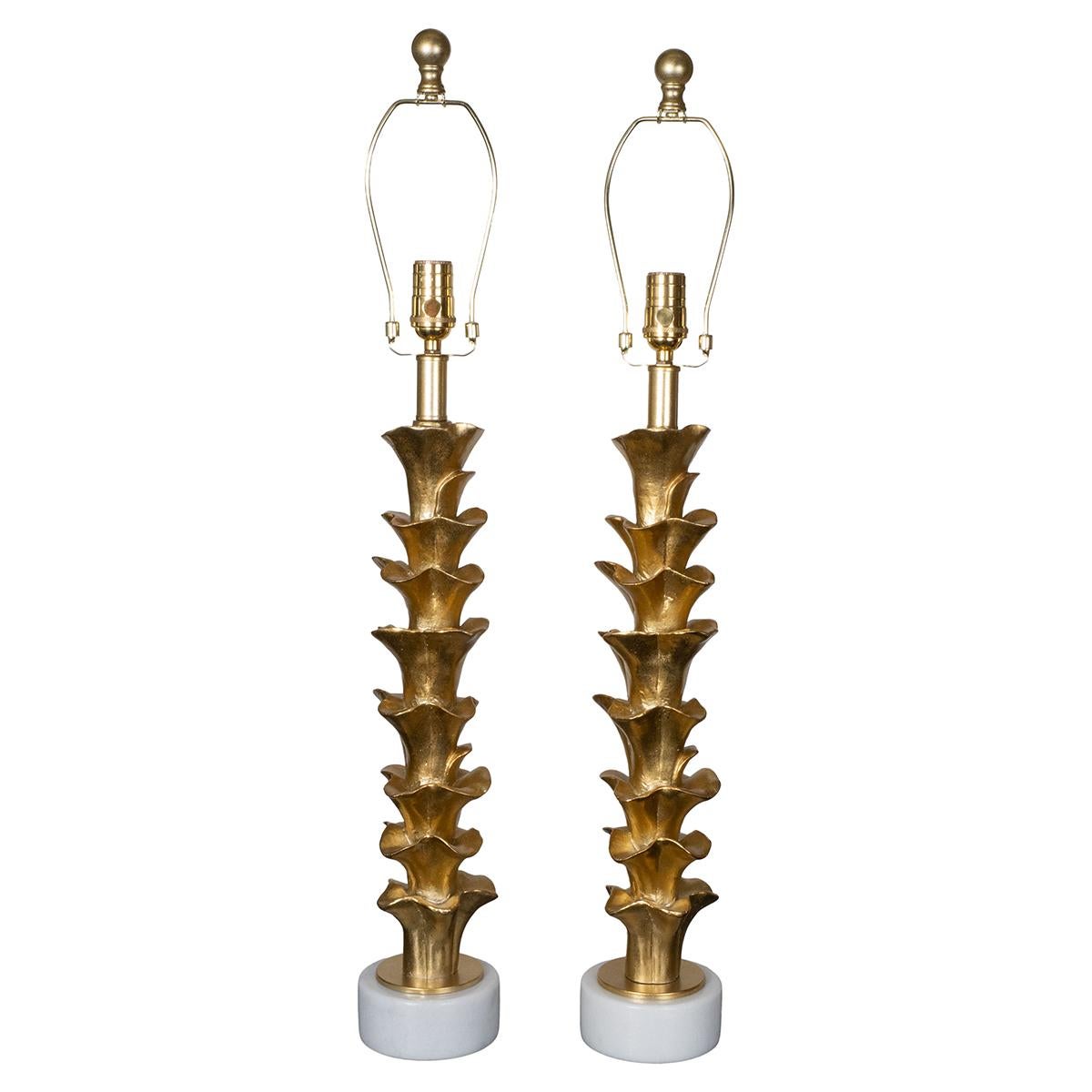 Pair of organic form composition table lamps on stone bases with golden gilt-like finish.