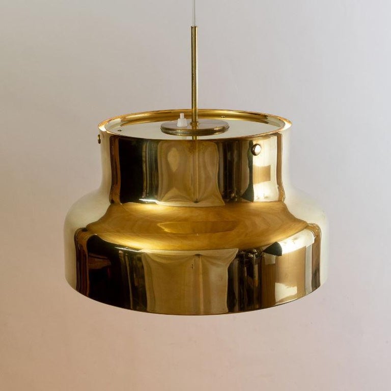 A pair of original 1970s golden Bumling editions by Anders Pehrson for Atelje Lyktan of Sweden. This Swedish design classic was produced in brass only during the early production years commencing, 1968. The light is part of the broader Bumling