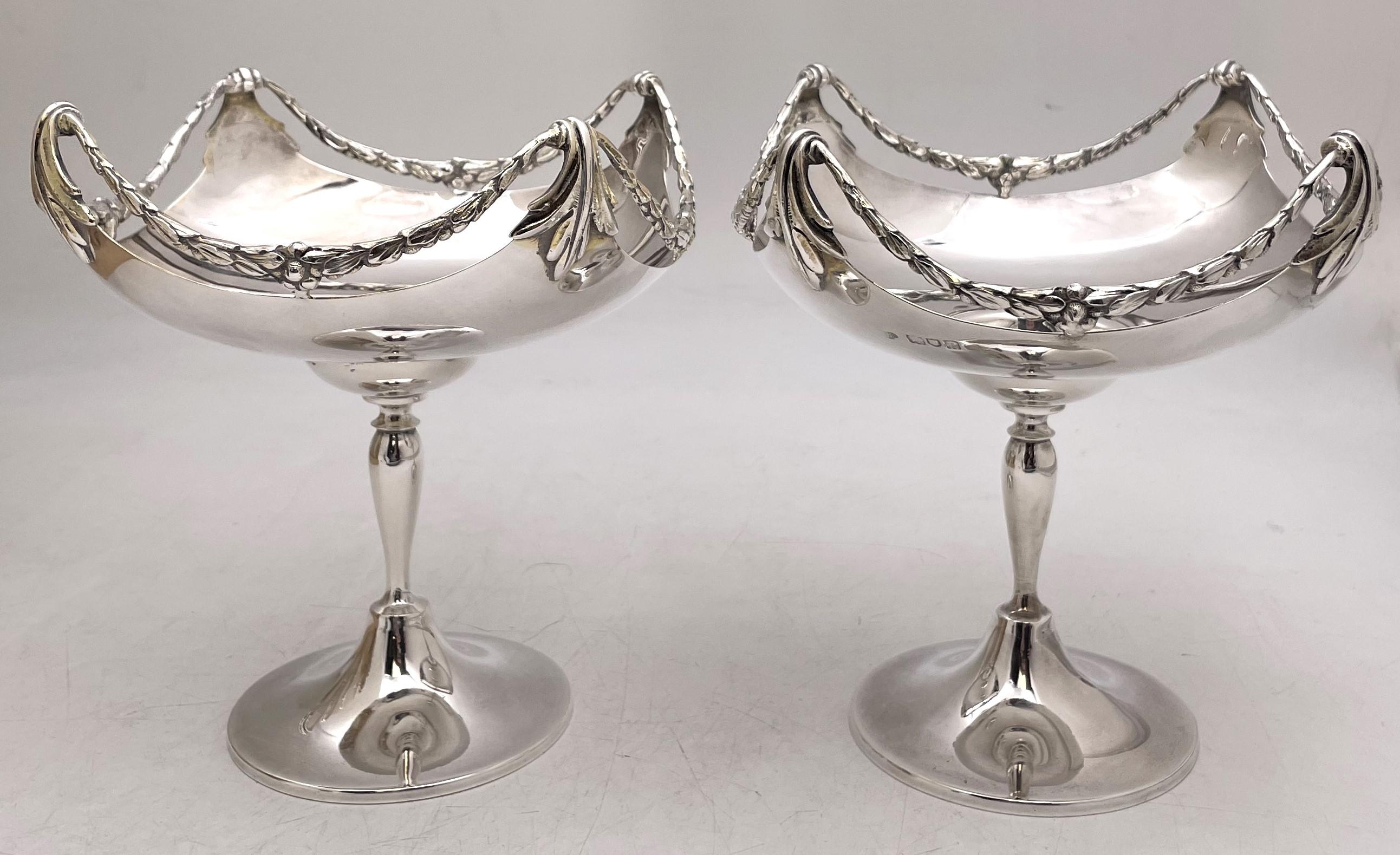 Pair of Goldsmiths & Silversmiths sterling silver compotes or footed bowls from 1910, beautifully adorned with wreath motifs. They measure approximately 7'' in height by 6 1/2'' in depth, weigh 22.7 troy ounces, and bear hallmarks as shown.