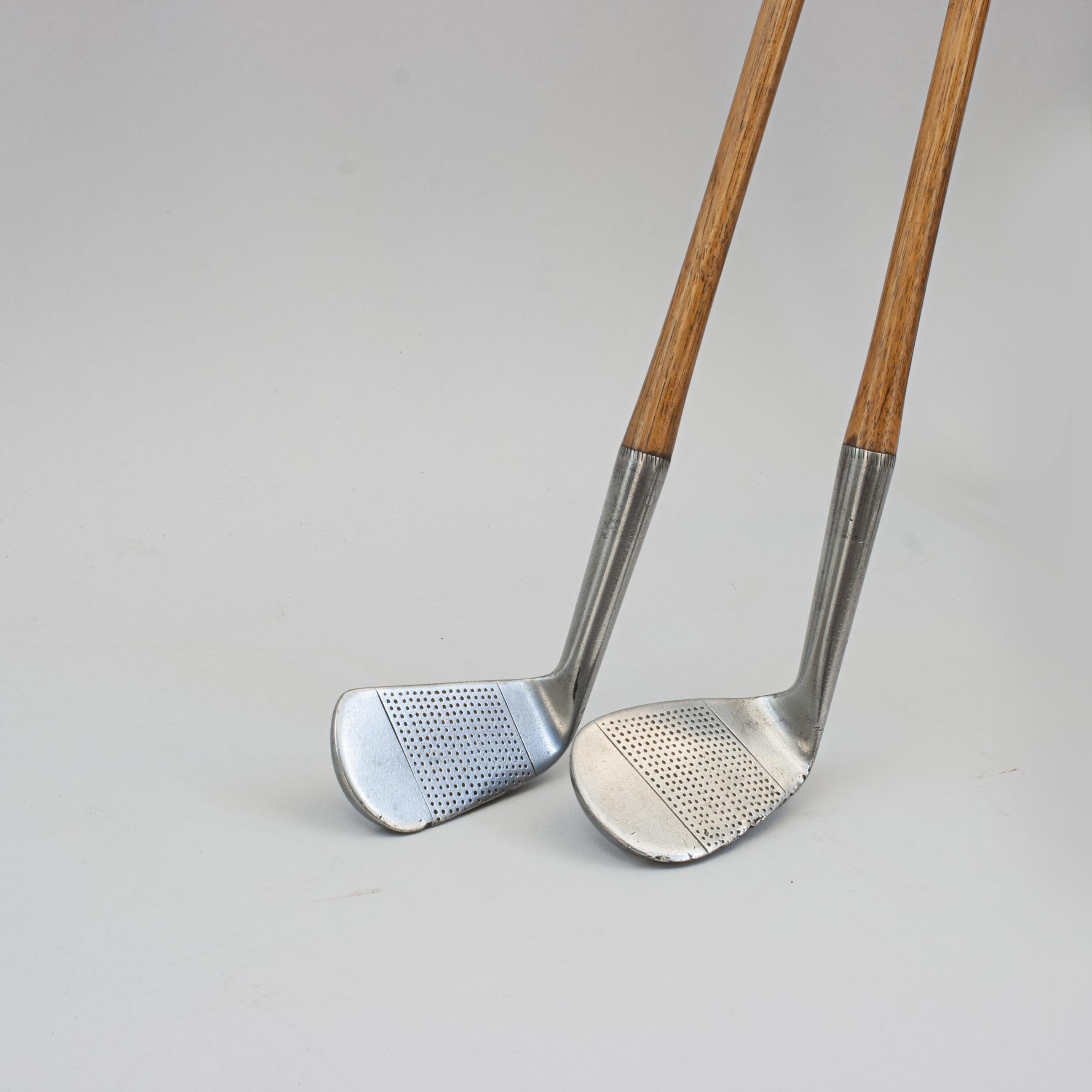 Pair Of R. Forgan Scotia Golf Clubs, Mashie And Niblick.
A good usable pair of hickory shafted 'Scotia' branded golf clubs by Robert Forgan & Son Ltd. of St Andrews. The two clubs, Mashie and Niblick, have original hickory shafts with leather grips,