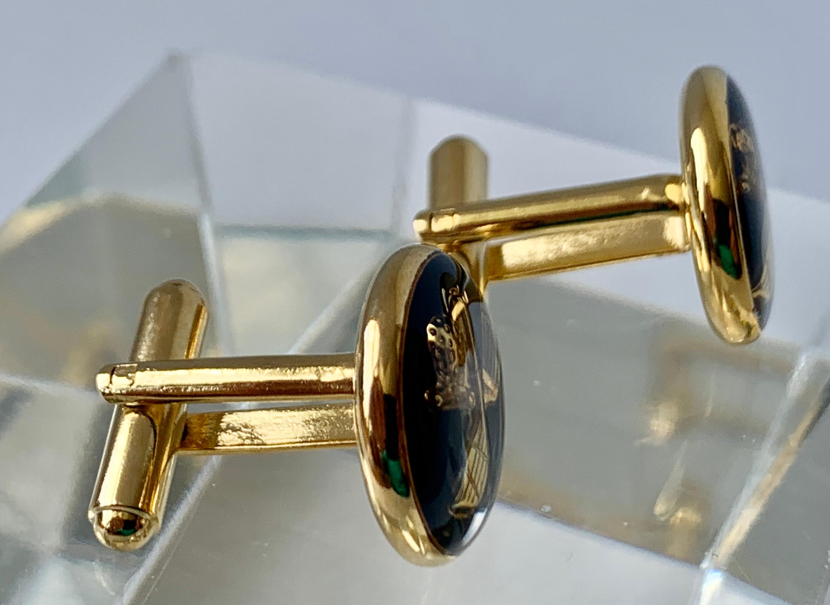 For the golfer a vintage pair of gold filled cufflinks.  The motif is crossed golf clubs with a golf ball on a black ground.  The backs are 