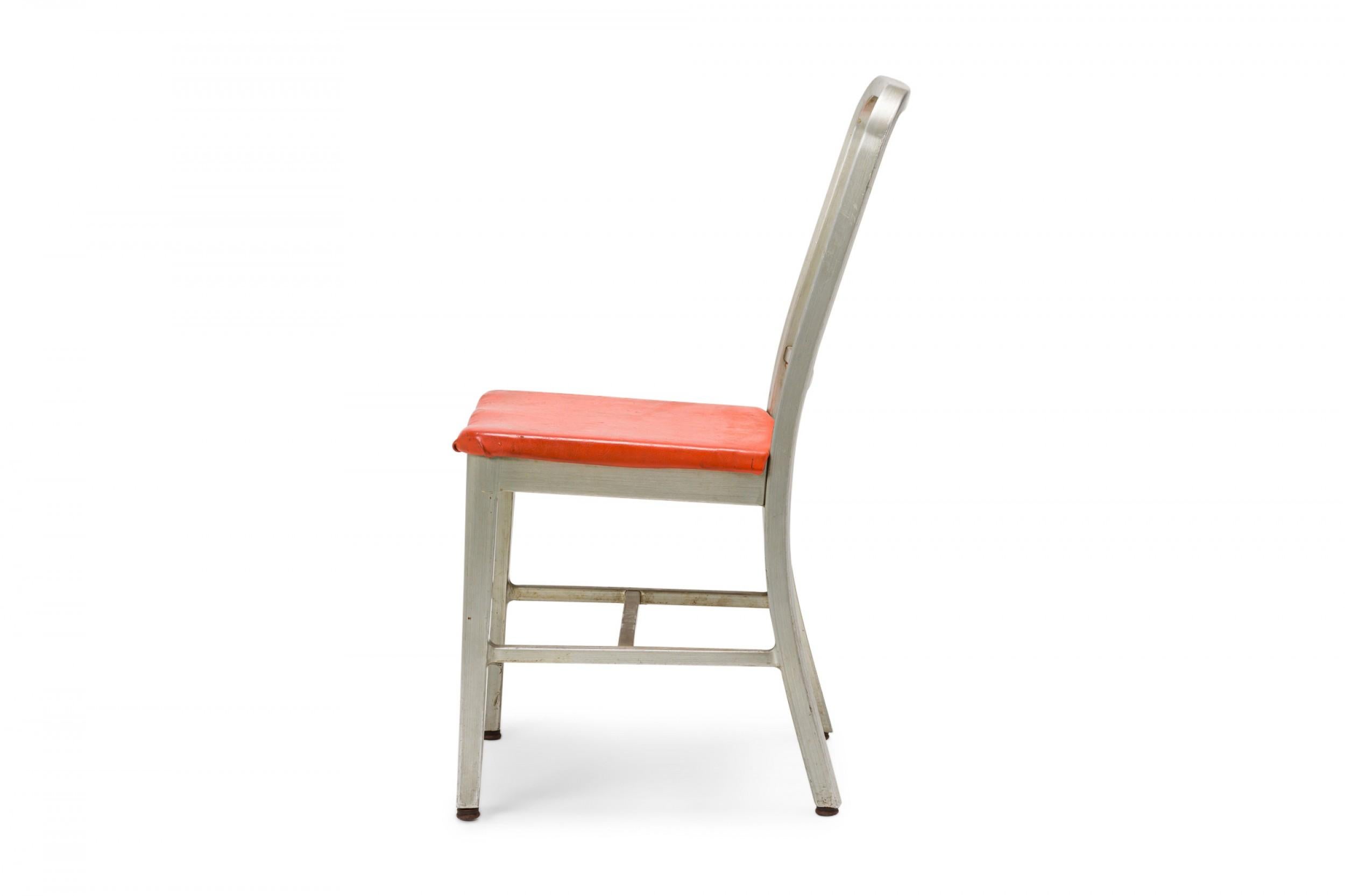 PAIR of American Mid-Century side chairs with aluminum frames, vertical slat backs, and red vinyl upholstered slip seats, resting on four square legs with stretcher bases. (GOODFORM)(PRICED AS PAIR)

Condition: Good; Wear consistent with age and use