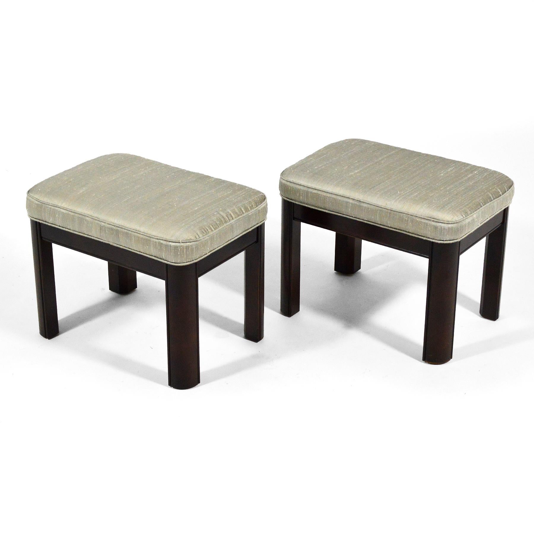This handsome pair of stools by Gordon's Furniture have seats upholstered in silk supported by mahogany bases.