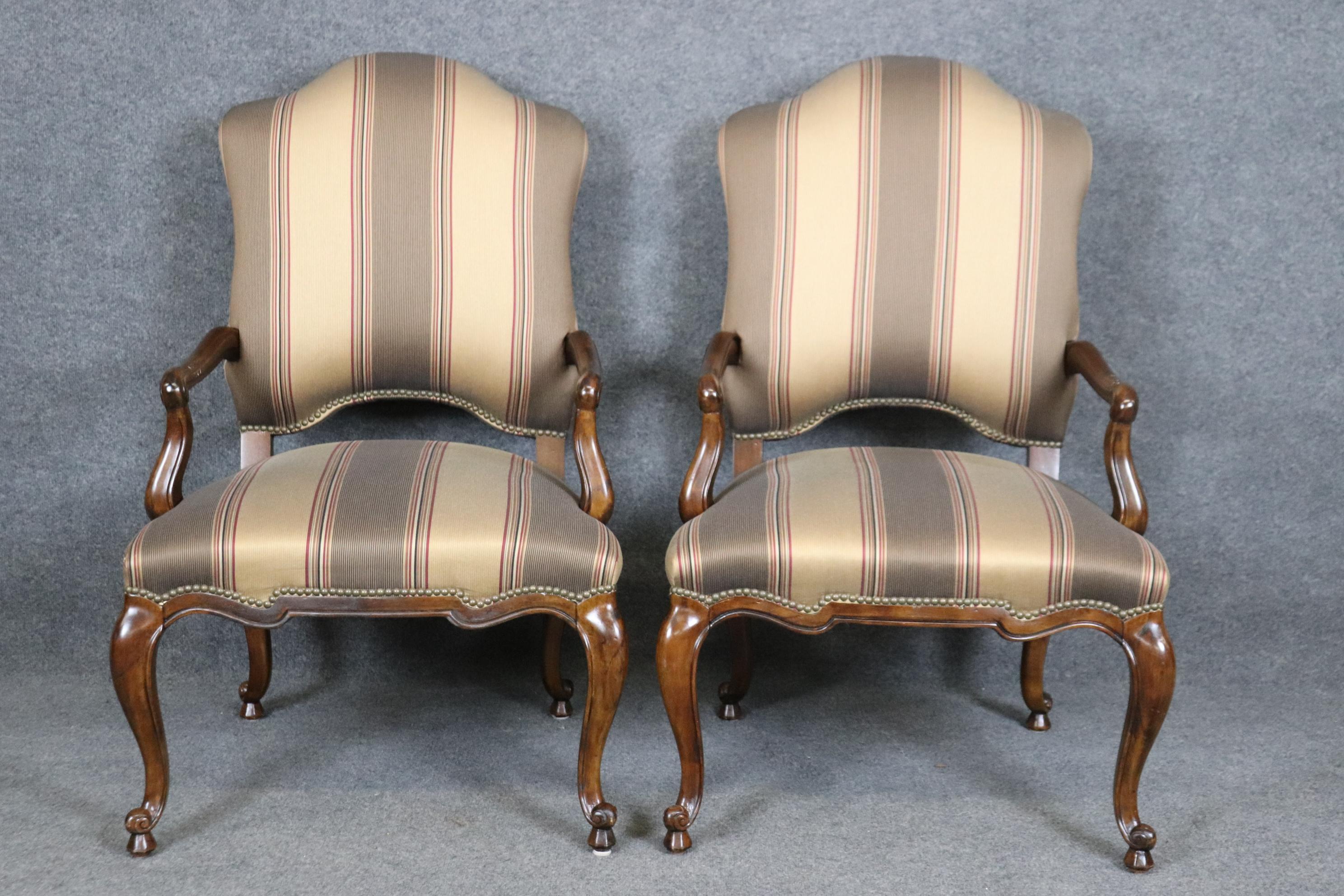 This is a gorgeous pair of solid walnut Century armchairs made by Century of North Carolina and are in good condition with minimal wear and signs of use. The chairs have beautiful upholstery. Measures 44.5 tall x 27.5 wide x 30.25 deep and seat
