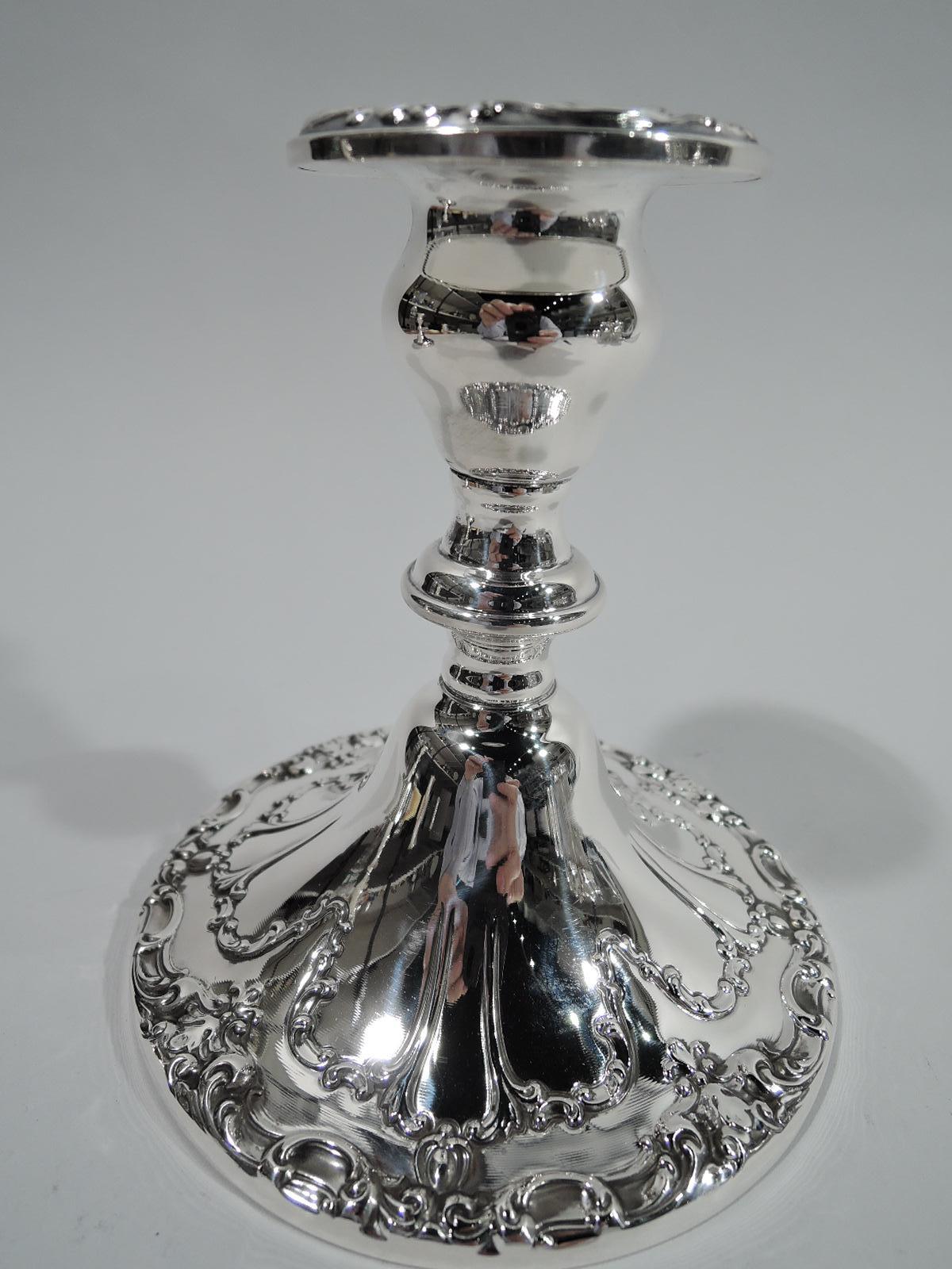 Pair of Chantilly-Duchess sterling silver low-candlesticks. Made by Gorham in Providence. Each: Urn socket, knopped support, and raised and round foot. Low-relief scroll and flower ornament. A sweet house-warming gift. Fully marked including no.